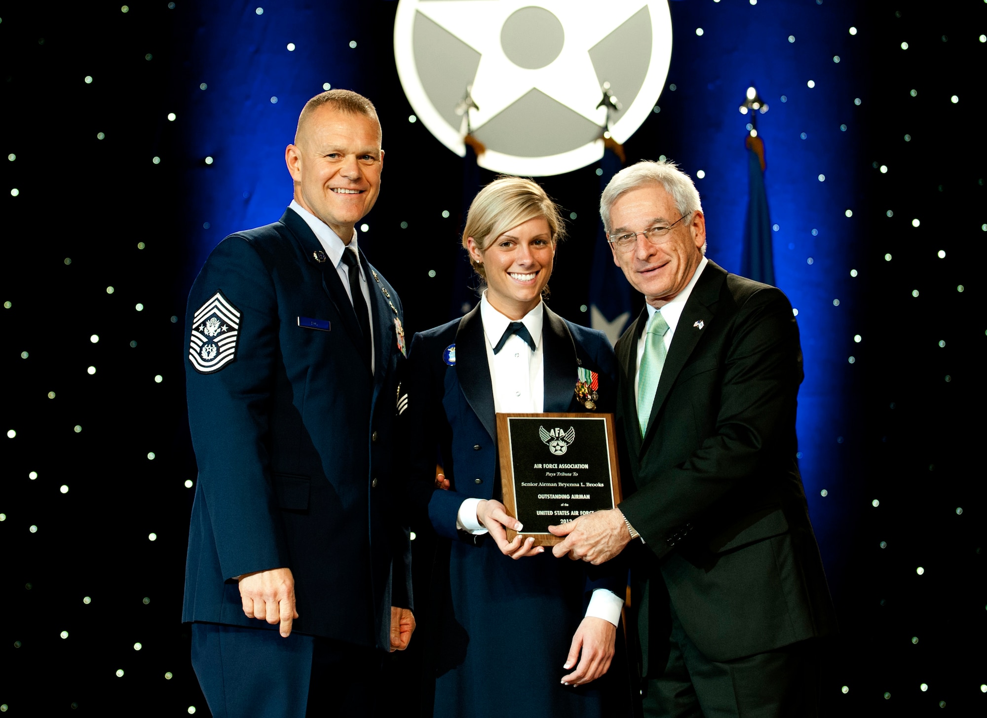 Chief Master Sgt. of the Air Force James Roy, left, and Sandy Schlitt, right, Air Force Association's chairman of the board, present a plaque to Senior Airman Bryenna Brooks during the 12 Outstanding Airmen of the Year reception and awards dinner in Washington, D.C., Sept. 17, 2012. The recipients were recognized for superior leadership, job performance, community involvement and personal achievements. Brooks is with the 2nd Medical Operations Squadron from Barksdale Air Force Base, La. (U.S. Air Force photo/Jim Varhegyi)