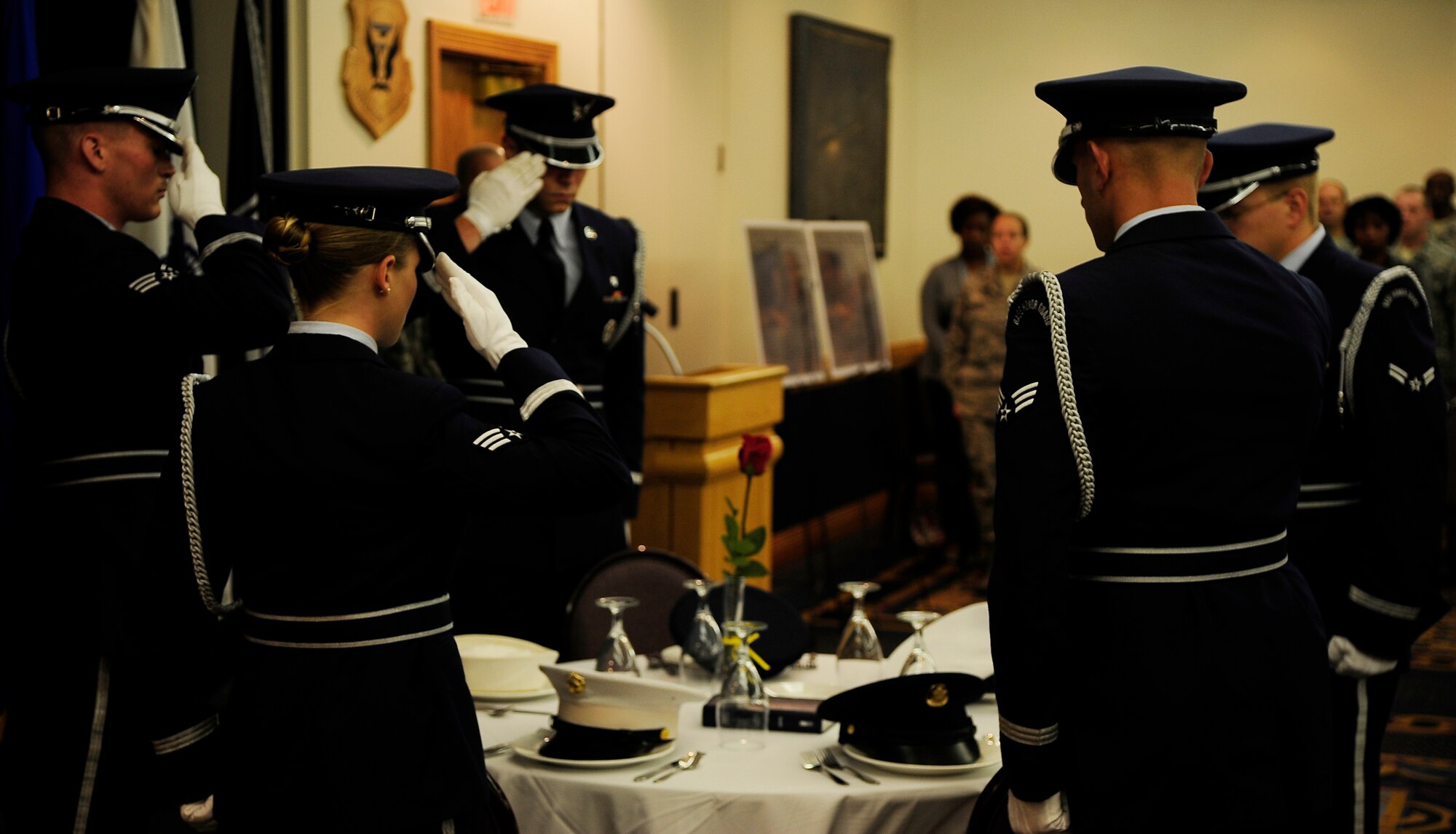 Honor Guard members salute empty spots representing those who could not be there during a prisoner of war and missing-in-action breakfast at Whiteman Air Force Base, Mo., Sept. 14. The POW/MIA breakfast showed respect and support to those who have sacrificed for our country and the families they may have left behind. (U.S. Air Force photo/Senior Airman Cody H. Ramirez) (RELEASED)