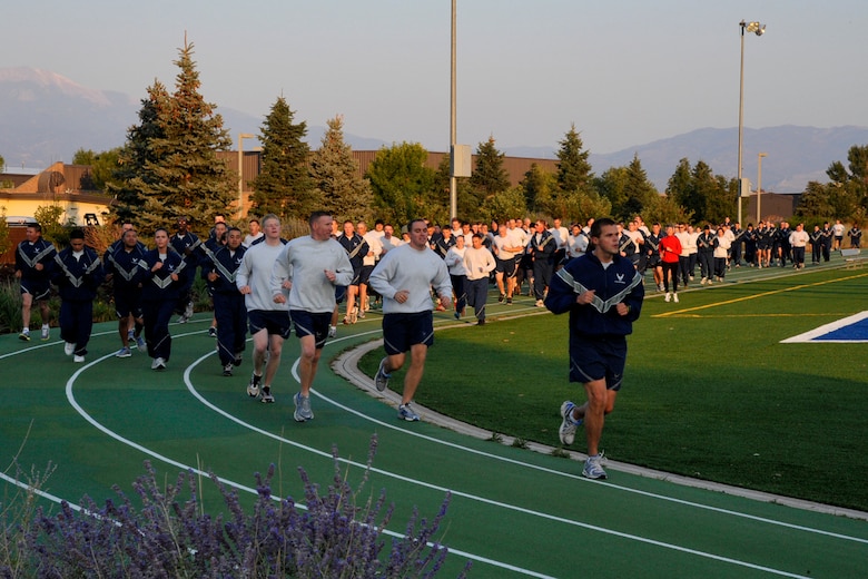 PETERSON AIR FORCE BASE, Colo. -- There was a lot of huffing and puffing Sept. 18, 2012, as Airmen ran, crunched and lunged their way around the newly renovated athletic field behind the fitness center. The grueling Wing Warfit was held in recognition of the Air Force’s birthday, and all that puffing is needed to blow out the 65 candles on the Air Force’s birthday cake. (U.S. Air Force photo/Rob Lingley)