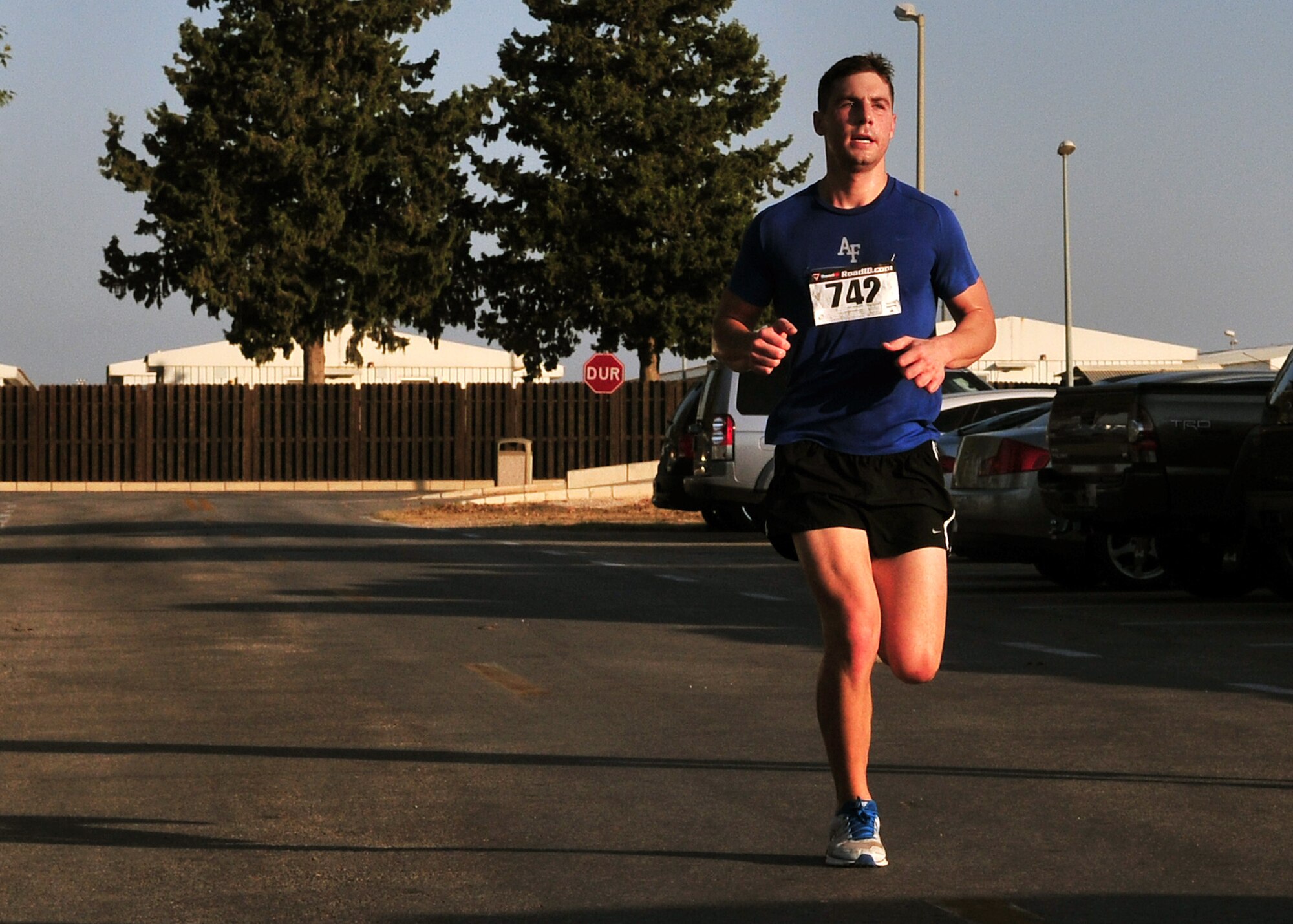 2nd Lt. Kyle Southard, 39th Air Base Wing protocol, crosses the finish line as the winner of the Incirlik half marathon with a time of 1 hour 26 minutes and 19 seconds Sept. 15, 2012, at Incirlik Air Base, Turkey. More than 80 Team Incirlik members ran in the half marathon. (U.S. Air Force photo by Senior Airman Daniel Phelps/Released)