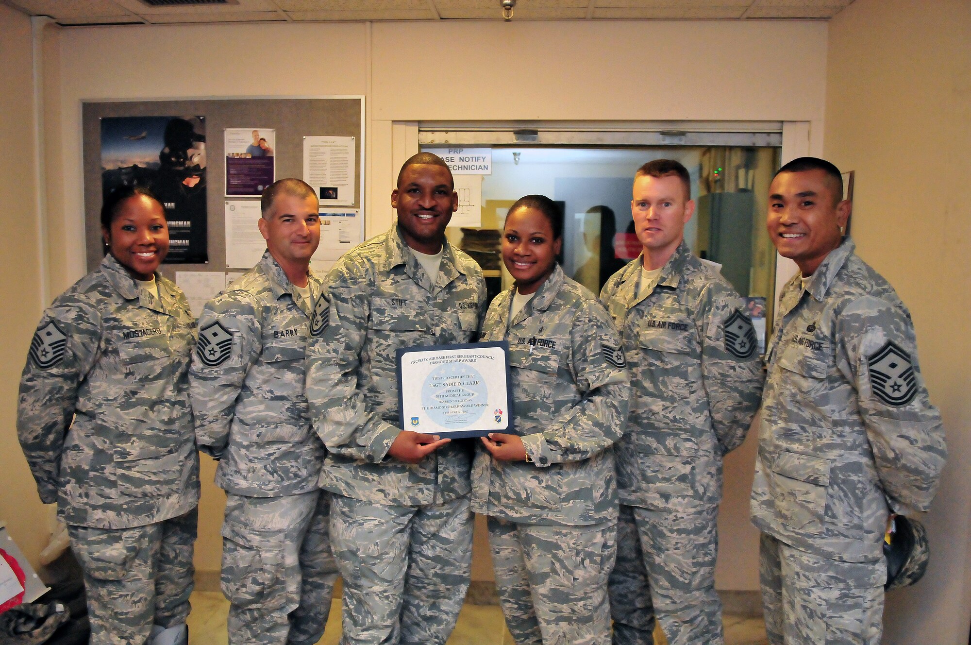 Tech. Sgt. Sadie Clark, 39th Medical Operations Squadron, is presented the August 2012 Diamond Sharp Award by members of the Incirlik First Sergeant Council Sept. 18, 2012, at Incirlik Air Base, Turkey. Clark earned the monthly award by distinguishing herself through outstanding professionalism, performance and display of the Air Force core values. (U.S. Air Force photo by Senior Airman Daniel Phelps/ Released)