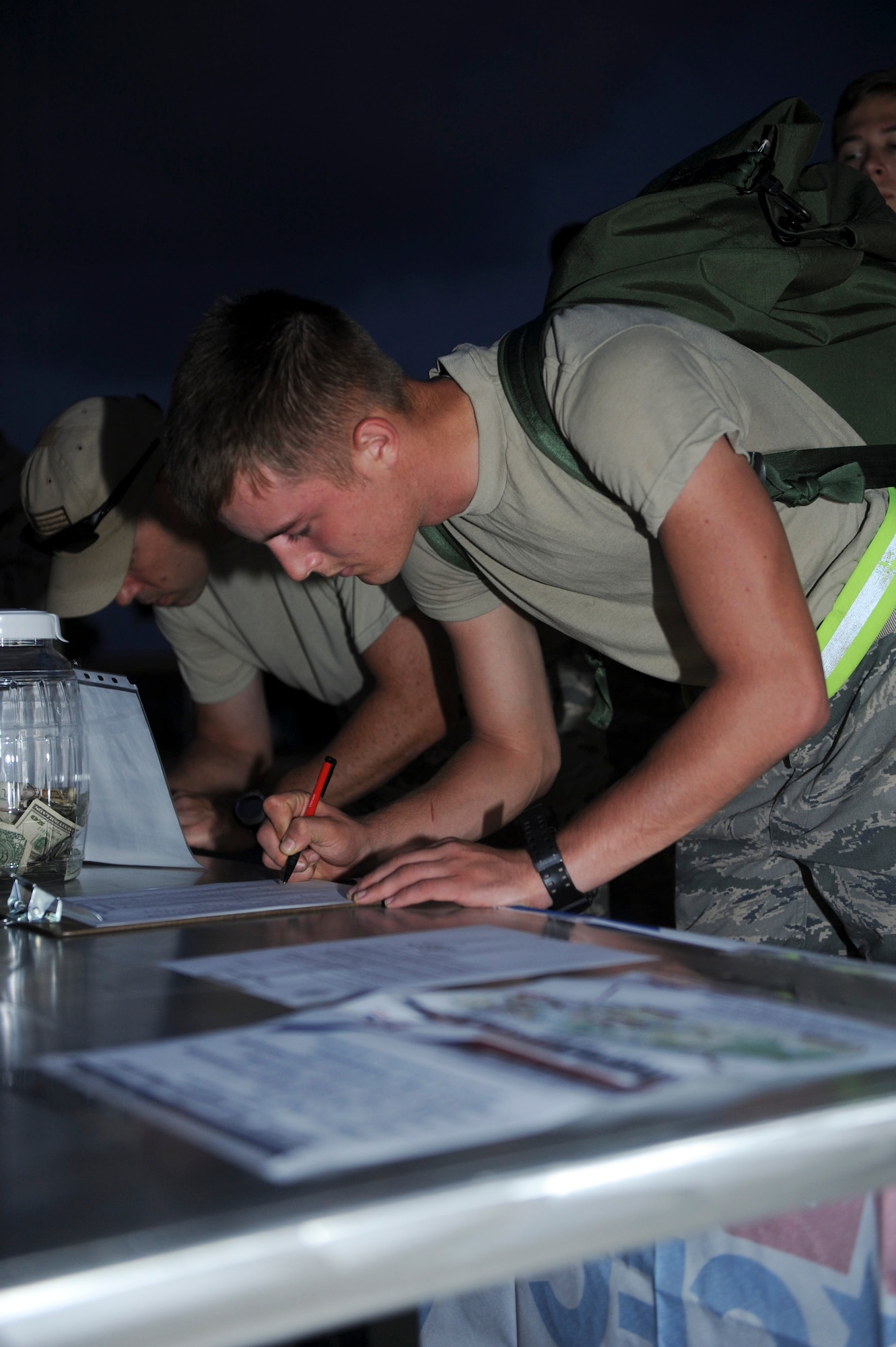 U.S. Air Force Airman 1st Class Kollin Ailworth, 18th Civil Engineering Squadron heating, ventilation and air conditioning technician, signs in as a participant for the 2012 Combined Federal Campaign kick-off 10K RuckMarch on Kadena Air Base, Sept. 19, 2012. The kick-off raised more than $400 and will be donated toward Team Kadena’s goal of $451,000 for various charities. (U.S. Air Force photo/Airman 1st Class Hailey R. Davis)