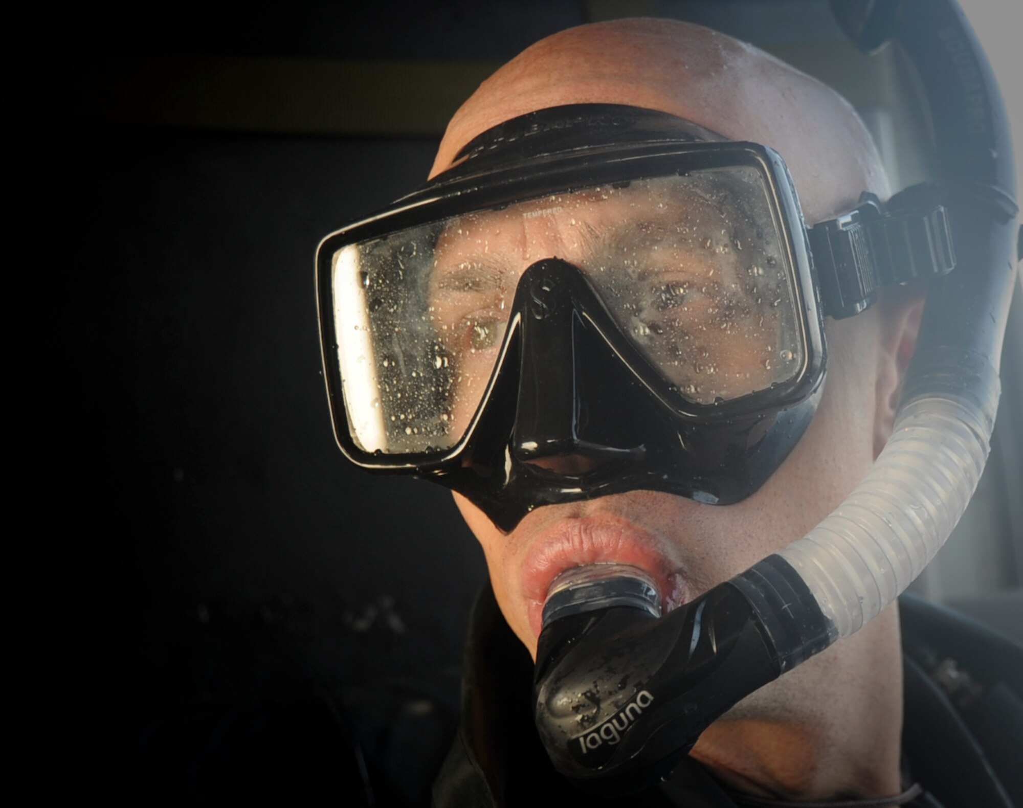 U.S. Air Force Capt. Joseph Lopez, 31st Rescue Squadron pararescueman, prepares to jump out the side of a U.S. Air Force HH-60 Pavehawk helicopter for the second time during the days training on Okinawa, Japan, Sept. 18, 2012. Pararescuemen are experts in medical care and small-unit tactics providing survivor contact, treatment and extraction during combat rescue operations in hostile or denied territory. (U.S. Air Force photo/Airman 1st Class Brooke P. Beers)