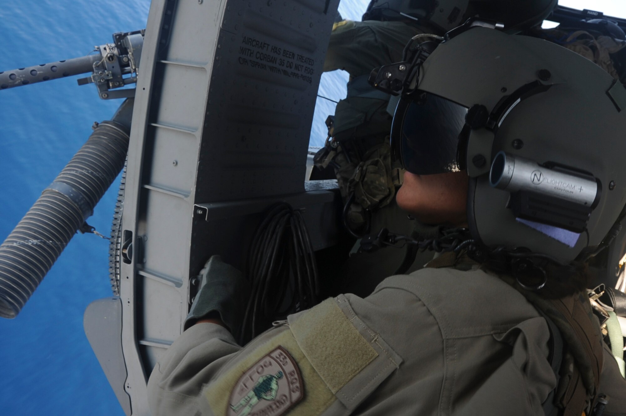 U.S. Air Force 2nd Lt. Amy Banks, student pilot, watches as the 33rd Rescue Squadron completes a training scenario on Okinawa, Japan, Sept. 18, 2012.  For the next month, Banks will be stationed with the 33rd and will learn what it takes to pilot the U.S. Air Force HH-60 Pavehawk helicopter. (U.S. Air Force photo/Airman 1st Class Brooke P. Beers)