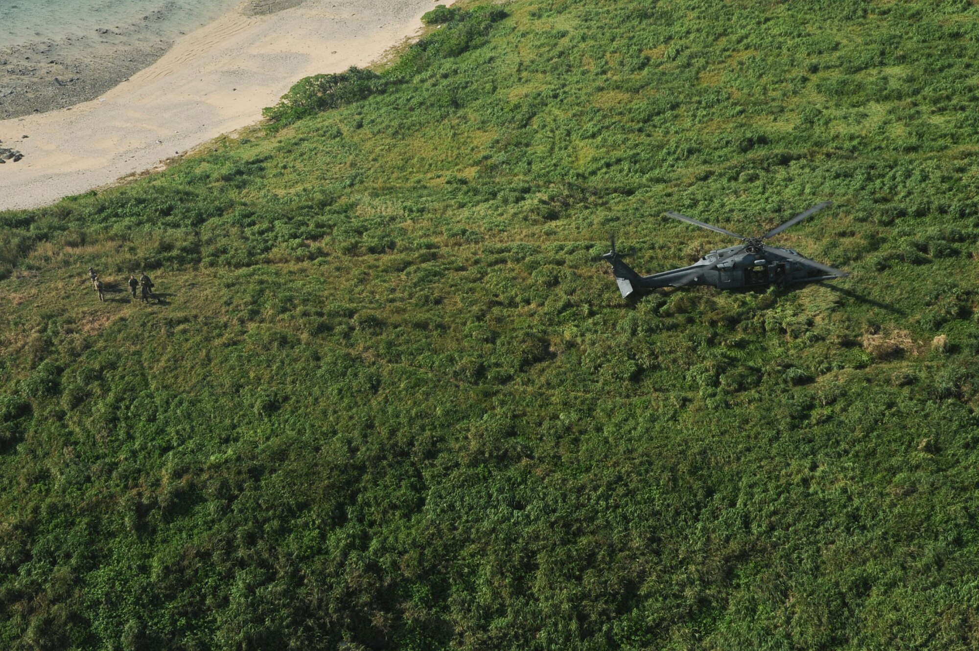 U.S. Air Force pararescuemen with the 31st Rescue Squadron and members of the 33rd Rescue Squadron perform a training scenario on an island off the coast of Okinawa Japan, Sept. 18, 2012. The Airmen were training to maintain standards and to prepare themselves for an upcoming deployment. (U.S. Air Force photo/Airman 1st Class Brooke P. Beers)