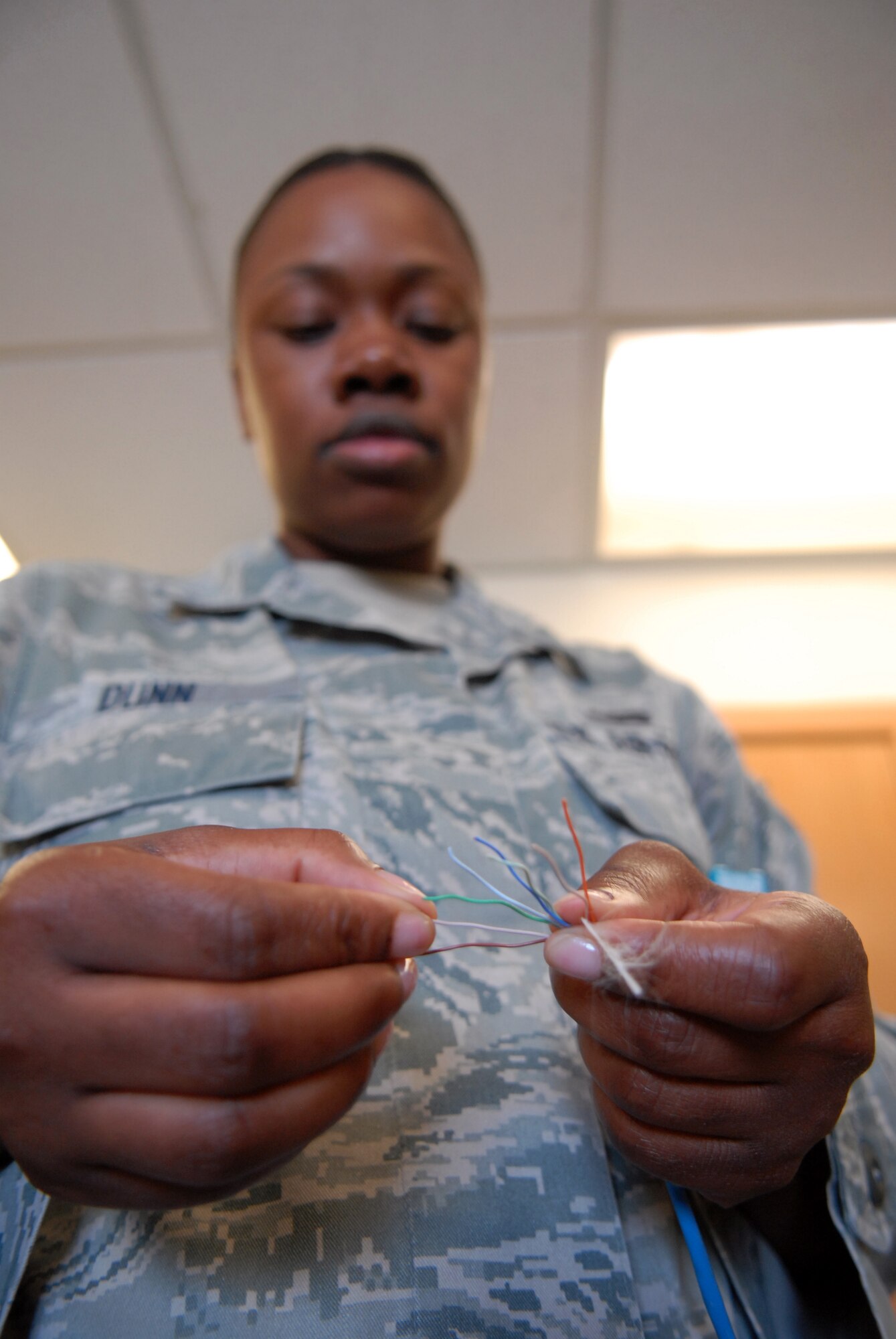 Senior Airman Regina Dunn, 8th Communication Squadron client systems technician, separates wires by their color code, while demonstrating how to make a Category 5 communication cable at Kunsan Air Base, Republic of Korea, Sept. 7, 2012. Technicians have the networking skills necessary to maintain computers, telephones, land mobile radios, and other communication desktop equipment. (U.S. Air Force photo/ Staff Sgt. Tong Duong)