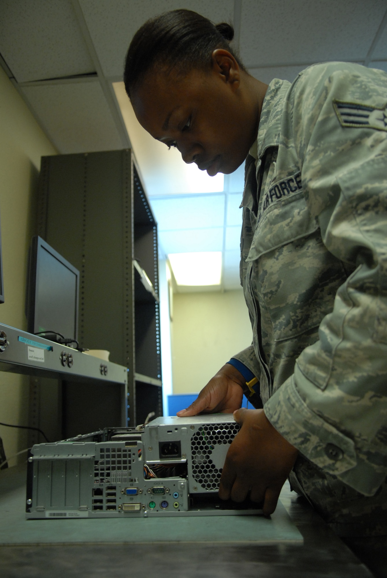 Senior Airman Regina Dunn, 8th Communication Squadron client systems technician, installs a power supply unit to a customer’s computer at Kunsan Air Base, Republic of Korea, Sept. 7, 2012. Technicians troubleshoot 100 to 150 computers a week. (U.S. Air Force photo/ Staff Sgt. Tong Duong)