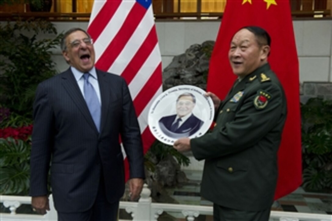 Secretary of Defense Leon E. Panetta laughs as he is presented with a plate commemorating his visit to China by Chinese Minister of National Defense Gen. Liang Guanglie after an official dinner in Beijing, China, on Sept. 18, 2012.  Panetta and Liang met earlier to discuss regional security issues of interest to both nations.  Panetta visited Tokyo, Japan, before continuing to Beijing and will travel to Auckland, New Zealand, on a weeklong trip to the Pacific.  