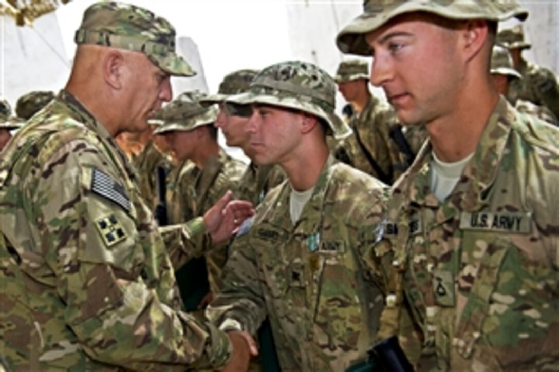 U.S. Army Chief of Staff Gen. Ray Odierno shakes the hand of a soldier after presenting him with an Army Commendation Medal for valor during a ceremony on Forward Operation Base Zangabad, Afghanistan, Sept. 18, 2012. 