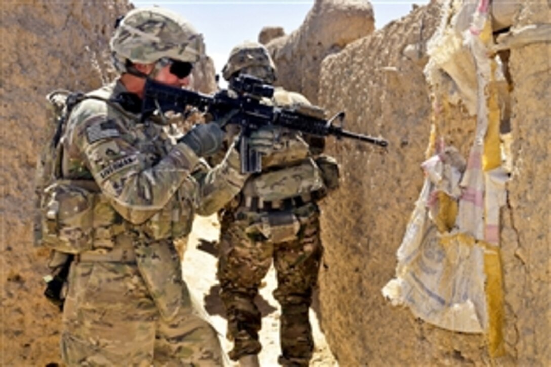 U.S. Army Cpl. Bobby Liverman, left, clears an area during Operation Southern Strike III in Jandad Kalay village in the Spin Boldak district of Afghanistan's Kandahar province, Sept. 9, 2012. 