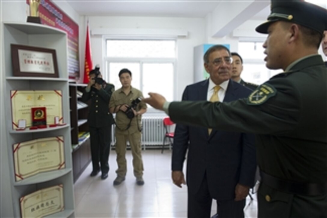 A cadet of the People's Liberation Army Armored Forces Academy shows Secretary of Defense Leon E. Panetta the most difficult medals to win while in the academy during Panetta's tour of the barracks in Beijing, China, on Sept. 19, 2012.  Panetta also met with Chinese Vice President Xi Jinping and his defense counterparts to discuss regional security issues of interest to both nations.  Panetta visited Tokyo, Japan, before continuing to Beijing and will travel to Auckland, New Zealand, on a weeklong trip to the Pacific.  
