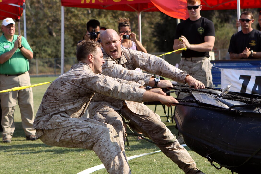Master Sgt. Christopher May and Sgt. Mark Rawson use the last of their energy reserves to drag a 250 pound Zodiac raft across the finish line of the 4th Annual Recon Challenge on Marine Corps Base Camp Pendleton, Sept. 15. The 14 two-man teams traveled 29.4 miles and completed six tasks, putting their endurance, communication skills and commitment to mission accomplishment to the test.