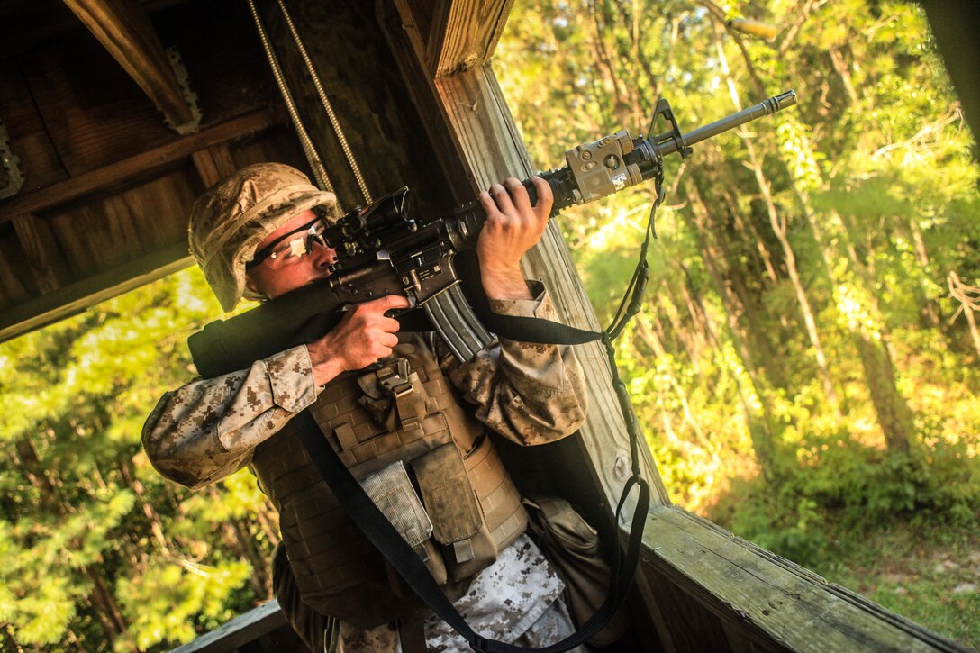 A Marine with 2nd Battalion, 8th Marine Regiment, competes in a 3 Gun Competition as part of the 2/8 Olympics. The unit gave their weathered camouflage utilities a week-long break to carry out a battalion size Olympics promoting unit cohesion and competitive spirits. 