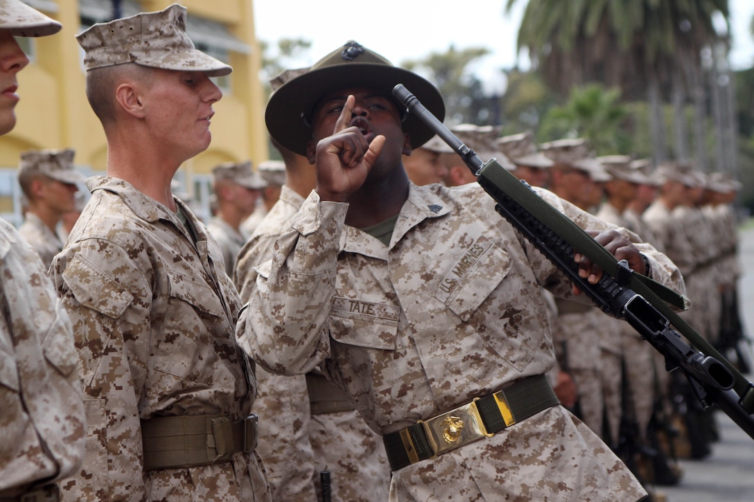 Sgt. Detren C. Tate, drill instructor, Plt. 3262, Company D, finds dirt on a recruit's rifle during their series commander inspection aboard Marine Corps Recruit Depot San Diego, Sept. 10. Recruits asked a series of question that varied on topics from Marine history to their general orders.
