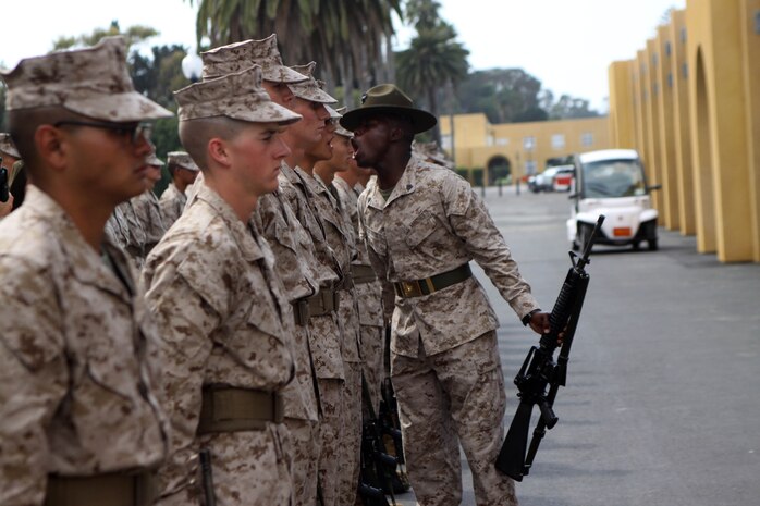 Recruits of Company M, 3rd Recruit Training Battalion, are inspected by Sgt. Detren C. Tate, drill instructor, Plt. 3262, during their series commander inspection aboard Marine Corps Recruit Depot San Diego, Sept. 10. Recruits were inspected for their bearing, uniforms and Marine knowledge. 