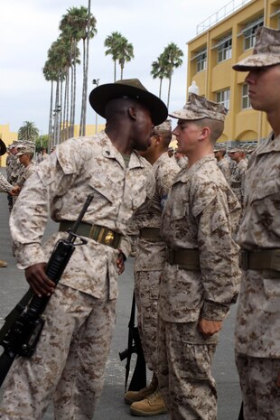 Recruits of Company M, 3rd Recruit Training Battalion, are inspected by Sgt. Detren C. Tate, drill instructor, Plt. 3262, during their series commander inspection aboard Marine Corps Recruit Depot San Diego, Sept. 10. Recruits were inspected for their bearing, uniforms and Marine knowledge. 
