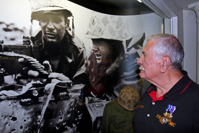 1st Sgt. Arthur Barbosa, a Marine veteran, looks at the display containing a photo taken of him more than 60 years ago. Barbosa was awarded the Navy Cross for his courageous actions while serving as a squad leader with Company E, 2nd Battalion, 5th Marines, 1st Marine Division during the Korean War in 1952. Barbosa is now a docent at the Marine Corps Recruit Depot San Diego Command Museum, where he and other Marine veterans share their stories about their experiences in the Marine Corps.  