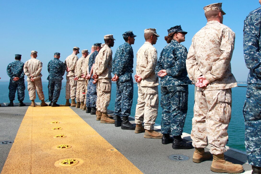 Marines and sailors with the 15th Marine Expeditionary Unit and USS Peleliu man the rails of the USS Peleliu Sept. 17.  The MEU embarked the ships of the Peleliu Amphibious Ready Group and pulled away from the pier at Naval Base San Diego for its deployment to the Western Pacific.