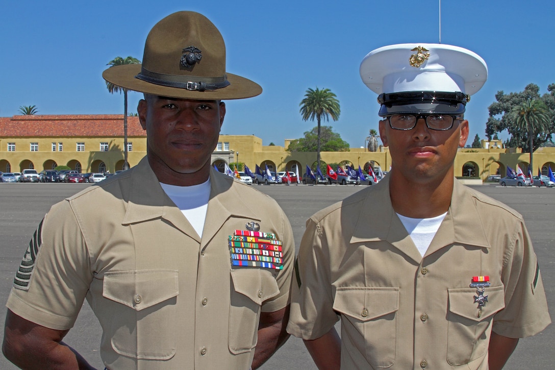Sgt. Maj. James K. Poterfield, sergeant major of Recruit Training Regiment, Marine Corps Recruit Depot Parris Island, S.C., stands with his newly graduated Marine son Pfc. Calvin A. Albright, Platoon 3201, Company I, 3rd Recruit Training Battalion, on the parade deck Sept. 14 aboard Marine Corps Recruit Depot San Diego. Albright, 21, enlisted in the Marine Corps to follow in his father's footsteps and to provide for his family. He had always looked up to his father's accomplishments and viewed him as his greatest influences and role model. Porterfield was given the opportunity to be the Parade Reviewing Officer of his son's graduation. "I'm speechless," explained Porterfield, 41. "The pride of being a father and a Marine and being able to share that with my son is a privillage." Poterfield graduated from MCRD San Diego 23 years ago and walked across the same parade deck. "I felt proud to have my father there watching us as the parade reviewing officer," said Albright. "I really appreciate him and I know I have big shoes to fill."  