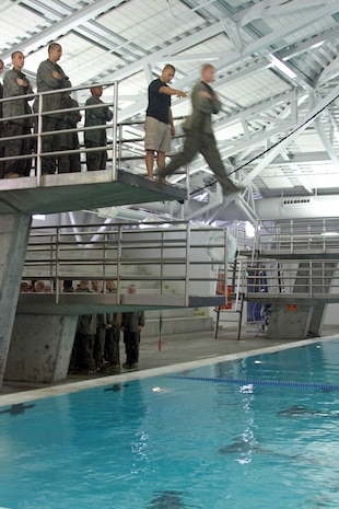 A recruit of Company K, 3rd Recruit Training Battalion, takes a step off the 10-foot high diving board Sept. 11 aboard Marine Corps Recruit Depot San Diego. Recruits are required to jump off into the deep end of the pool and swim 25-yards toward the shallow end. 