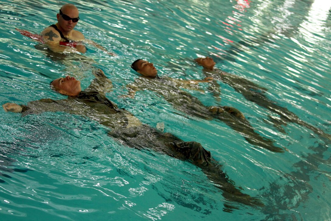 Recruits learn to tread water in the deep end of the pool Sept. 11 aboard Marine Corps Recruit Depot San Diego. They are required to tread water for a total of four minutes while wearing a full uniform and combat boots. Treading water allows a swimmer to keep their head above water while staying in one area.