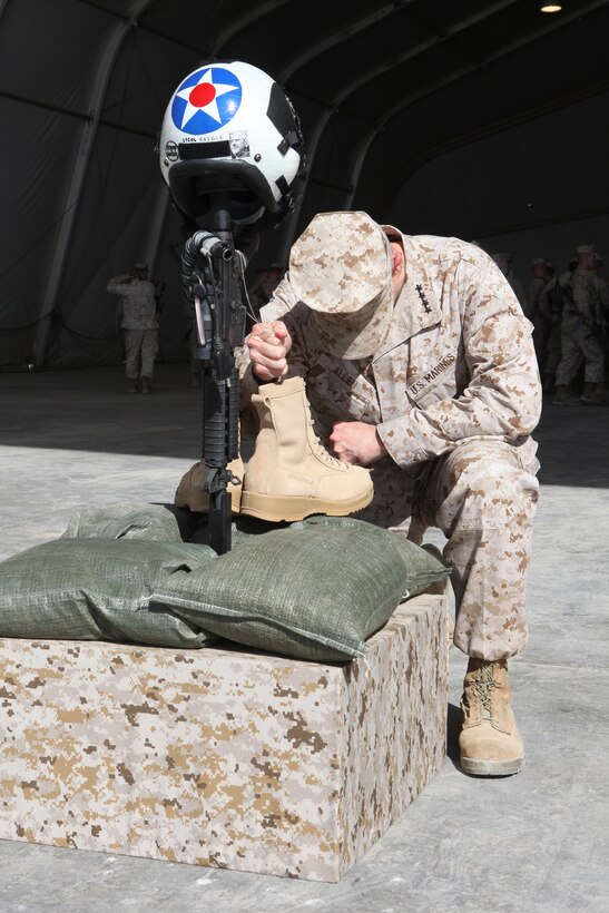 U.S. Marine Corps Gen. John R. Allen, commander, International Security Assistance Force, pays tribute to Lt. Col. Christopher K. Raible at Camp Bastion, Helmand province, Afghanistan Sept. 19, 2012. Raible, commanding officer of Marine Attack Squadron (VMA) 211, Marine Aircraft Group 13, 3D Marine Aircraft Wing (Forward), was killed in action while repealing an enemy attack on Camp Bastion Sept. 14, 2012. (U.S. Marine Corps photo by Sgt. Keonaona C. Paulo/Released)