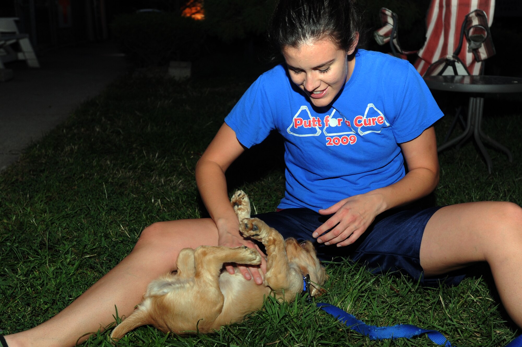 Airman 1st Class Elizabeth Hinz, 303rd Intelligence Squadron, plays with Pancake, one of Homeward Bound Animal Shelter’s new arrivals, during the evening volunteer shift Sept. 19, 2012, at Osan Air Base, Republic of Korea. Each day, volunteers clean the animals’ kennels and give them much-needed attention. (U.S. Air Force photo/Airman 1st Class Alexis Siekert)