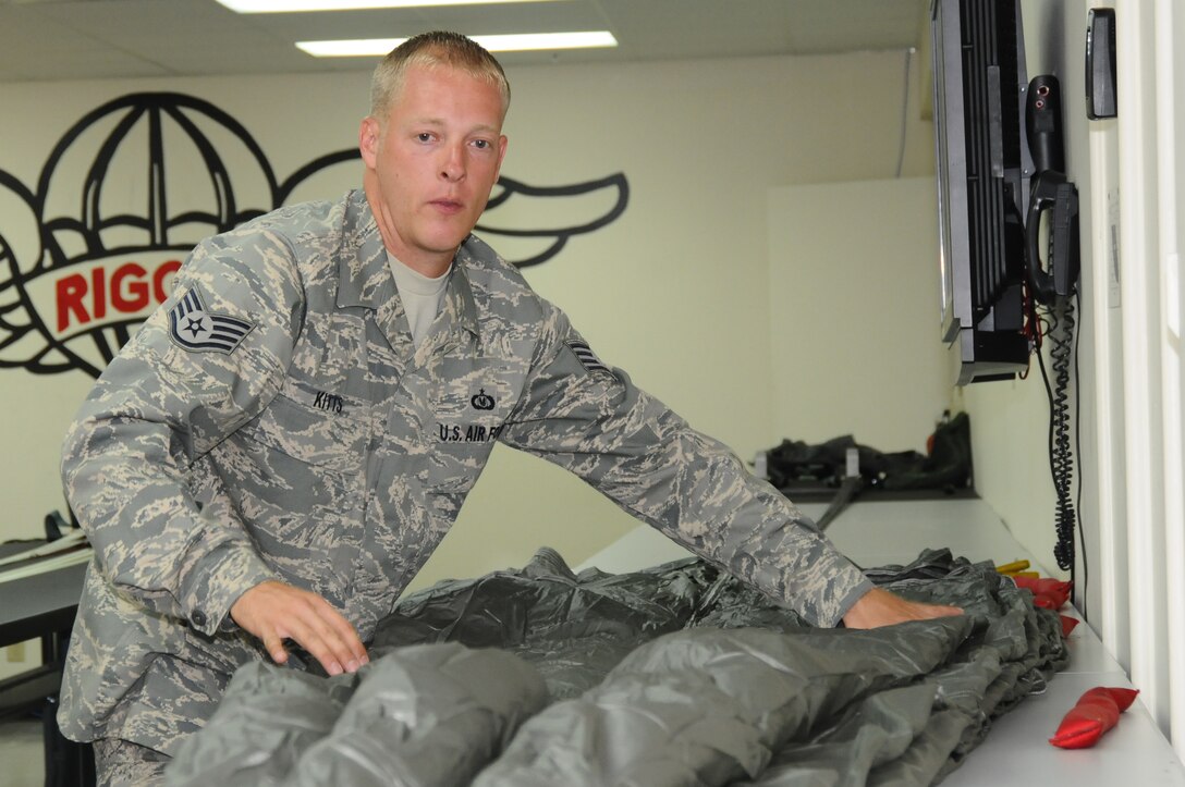 ANDERSEN AIR FORCE BASE, Guam – Staff Sgt. Christopher Kitts, 36th Operations Support Squadron aircrew flight equipment specialist flattens out the folded parachute prepping it for the final pack, Sept. 11. Every step of the packing procedure much be accomplished with 100 percent accuracy. (U.S. Air Force photo by Senior Airman Carlin Leslie)