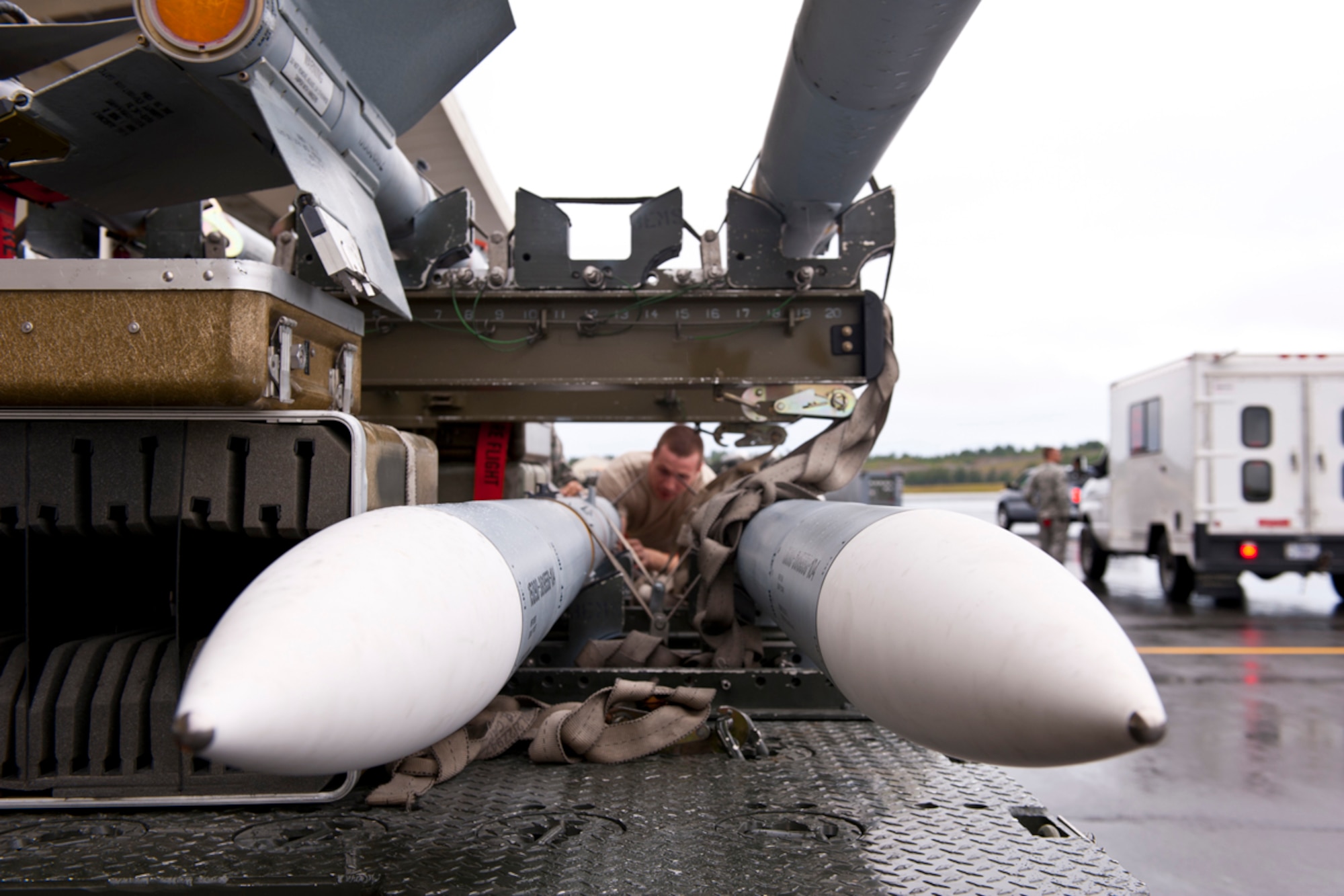 JOINT BASE ELMENDORF-RICHARDSON, Alaska -- An aircraft armament systems specialist with the 90th Aircraft Maintenance Unit examines an air intercept missile 9 for the fitting of fins that help guide the missile, August 20, 2012. The Airman participated in an excersize for their unit.(U.S. Air Force Photo/ Airman 1st Class Omari Bernard)