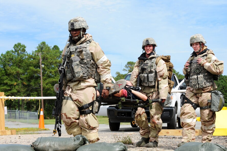 U.S. Air Force Airmen assigned to the 4th Security Forces Squadron carry a moulage patient on a litter after a simulated attack during Operational Readiness Exercise Coronet Warrior 12-04 at Base X on Seymour Johnson Air Force Base, N.C., Sept. 20, 2012. Airmen are trained to administer self-aid buddy care in order to assist the injured until medical technicians are available to take over. (U.S. Air Force photo/Airman 1st Class Aubrey Robinson/Released)