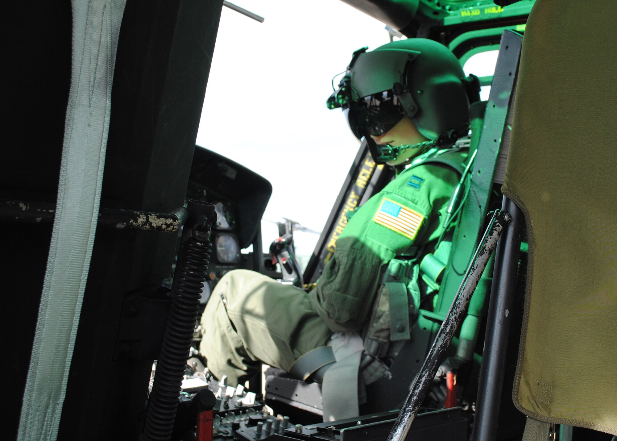 After strapping herself into a UH-1N Huey helicopter copilot seat during a preflight inspection, Capt. Cindy Tope, 40th HS UH-1N pilot and scheduler, listens for further instruction. (U.S. Air Force photo/Airman 1st Class Katrina Heikkinen)