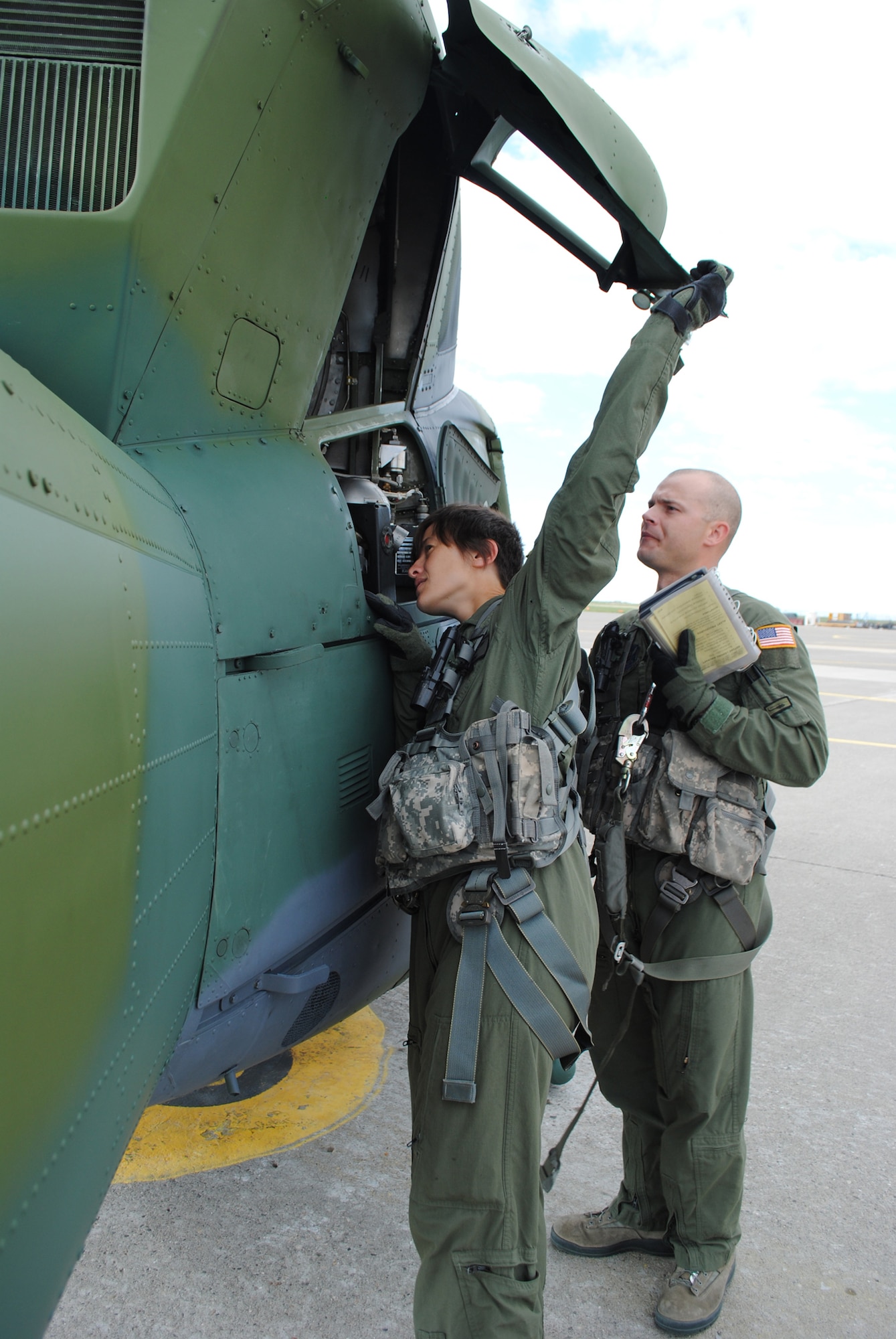 Tope and Galasso review a checklist during a training sortie June 8. The aircrew was preparing for the upcoming Global Strike Challenge competition at Camp Guernsey, Wyo., scheduled for Oct. 3 to 6. (U.S. Air Force photo/Airman 1st Class Katrina Heikkinen)