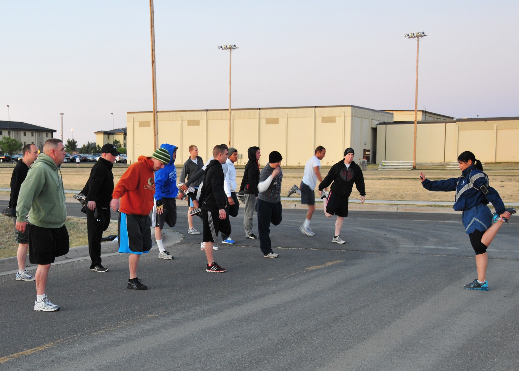 Staff Sgt. Hangie De Los Santos, 341st Force Support Squadron fitness specialist, leads a group of Team Malmstrom members through stretches before participating in the base’s final 5K fun run on Sept. 13.   The top three finishers were Airman 1st Class Nathan Simons, 819th RED HORSE Squadron pavement and equipment operator, with a time of 18 minutes and 3 seconds; Airman 1st Class Samuel Champion, 341st Force Support Squadron member with a time of 19 minutes and 52 seconds; and Senior Airman Steven Johnson, 341st Missile Maintenance Squadron EMT technician, with a time of 19 minutes and 58 seconds.  (U.S. Air Force courtesy photo)