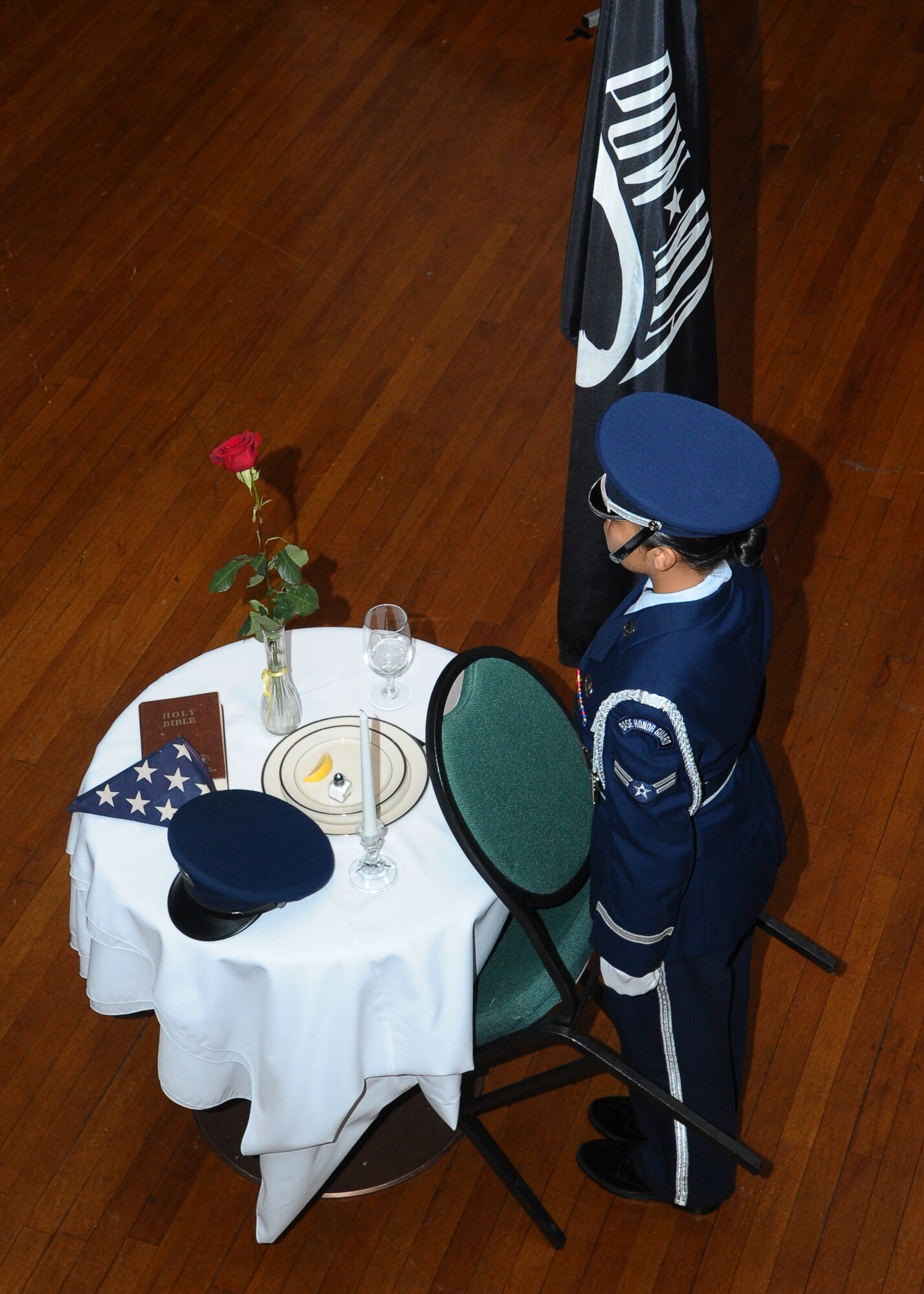 Airman 1st Class Denisse Ceci, 14th Comptroller Squadron performs the POW/MIA Missing Man ceremony during the 2012 Air Force Birthday Ball.  The Missing Man ceremony honors those who have been taken prisoner or have gone missing during wartimes.  (U.S. Air Force Photo/Airman 1st Class Charles Dickens)