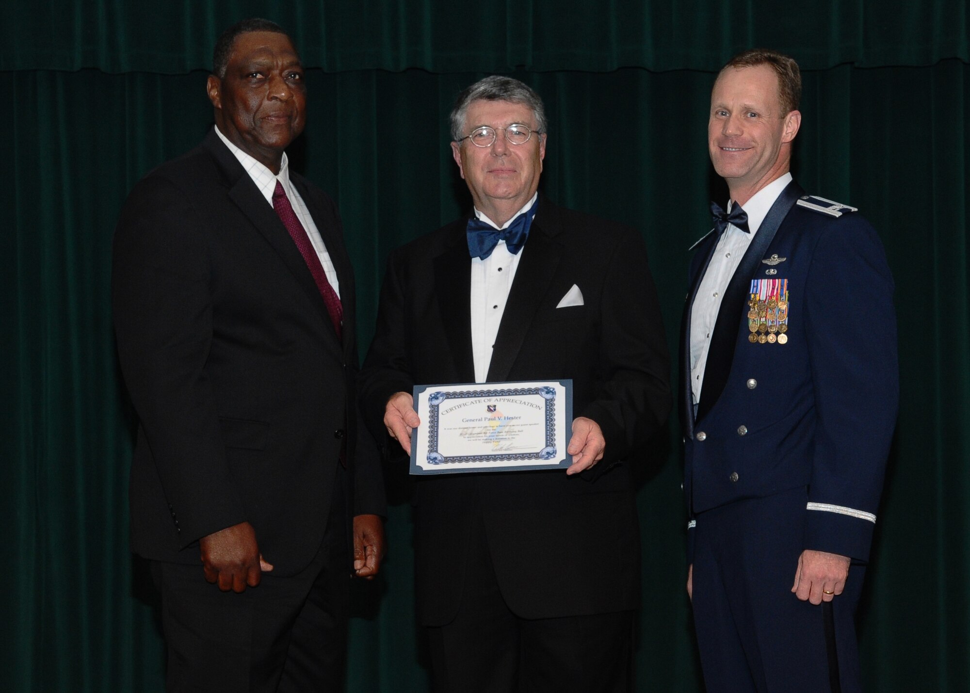 George Irby Jr. accepts a donation for the Happy Christmas Fund from retired Gen. Paul Hester and assists Col. Jim Sears, 14th Flying Training Wing Commander in presenting Hester with a Certificate of Appreciation.  The Happy Christmas Fund is an organization that donates clothes and other essentials to children in need.  (U.S. Air Force Photo/Airman 1st Class Charles Dickens)