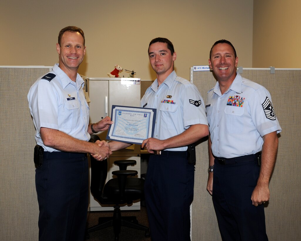 Airman 1st Class Michael Worth, 14th Contracting Squadron is awarded senior airman Below-The-Zone by Col. Jim Sears, 14th Flying Training Wing Commander and Chief Master Sgt. Vance Kondon, 14th Flying Training Wing Command Chief. (U.S. Air Force/Melissa Doublin)