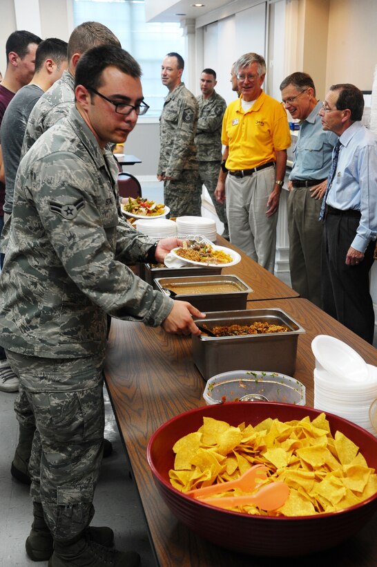 Airman 1st Class Henry Schultz grabs a plate of Mexican food at the Hispanic Heritage-themed Dorm Dinner Sept. 13 at the Chapel Annex.  The Military Affairs Committee hosted this Hispanic Heritage Month dinner for unaccompanied single Airmen living in the dorms.  (U.S. Air Force Photo/Airman 1st Class Charles Dickens)