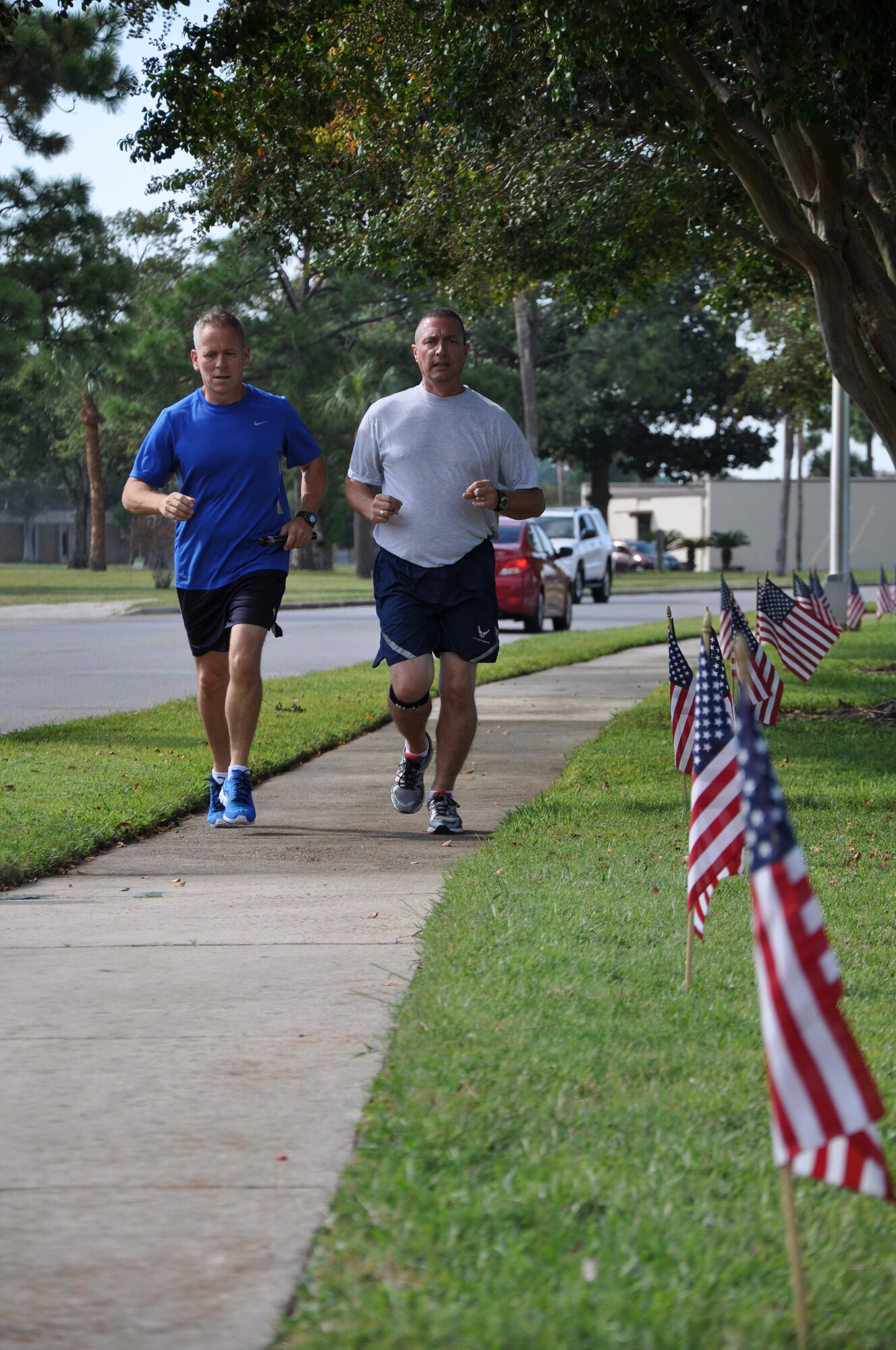 Brig. Gen. John McMullen, 325th Fighter Wing commander, and Chief Master Sgt. Richard Bruno, 325th Mission Support Group Superintendent, kick-off the annual 24-hour POW/MIA vigil run Sept. 20 at Flag Park. (U.S. Air Force photo by Staff Sgt. Rachelle Elsea)
