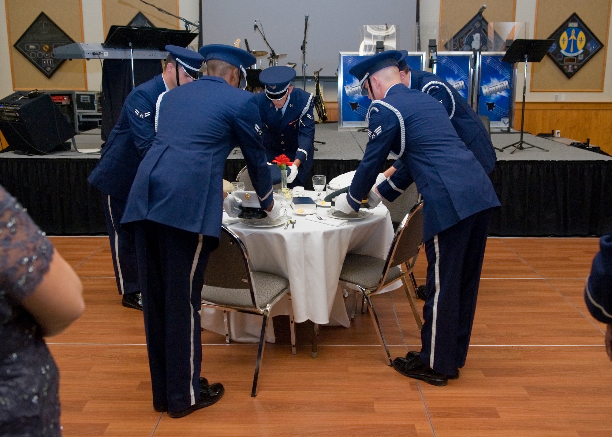 Members of Malmstrom’s Honor Guard place hats representing prisoners of war and persons missing in action within each branch of military service as part of the opening ceremonies for the Air Force Ball on Sept. 15.  (U.S. Air Force photo/Beau Wade)