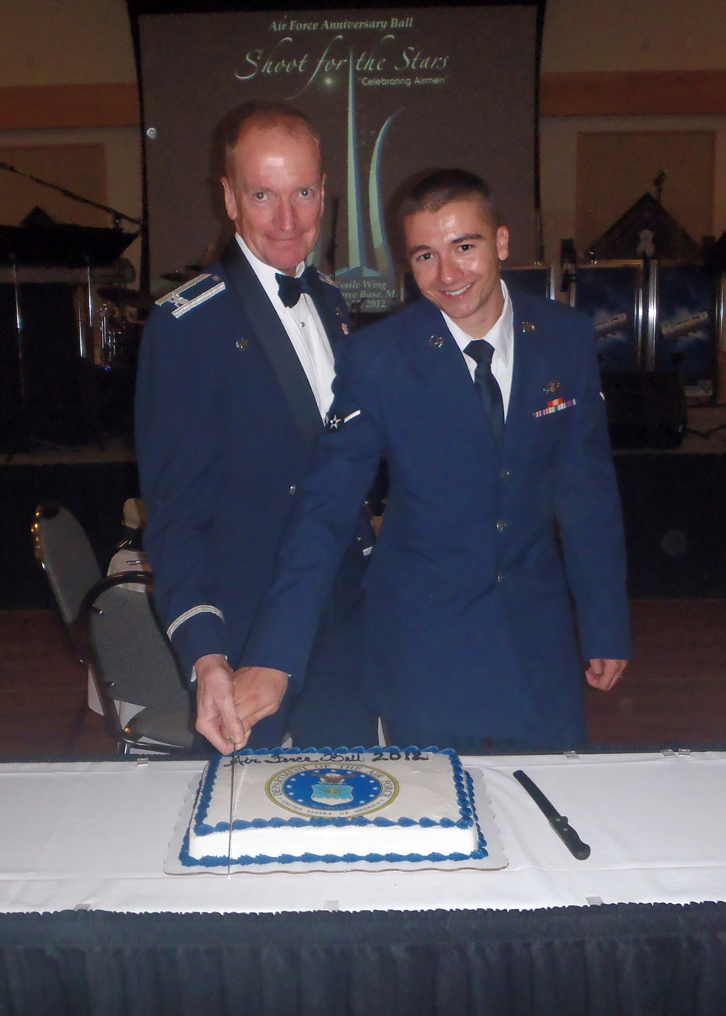 Col. David Lynch, 341st Security Forces Group commander, left, along with Airman Charles Schmidt, 341st Civil Engineer Squadron member, pose for a photo during the cake cutting ceremony at the Air Force Ball on Sept. 15 at the Grizzly Bend. Schmidt is Malmstrom Air Force Base’s newest Airman with a Total Active Federal Military Service Date of Jan. 17, 2012, and Lynch was the longest-serving Airmen at the ball with a TAFMSD of May 19, 1975.  (U.S. Air Force courtesy photo)