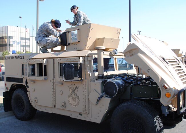 Airmen 1st Class Ella Cates, left, and Sarah Romberger, both 741st Missile Security Forces Squadron Convoy Response Force members, prepare one of the new 2012 Up-Armored Humvees on Sept. 18 for a trip to the missile complex the following day.  This vehicle is one of the first of 76 new Humvees that will become mission ready over the next few months.  (U.S. Air Force photo/Airman 1st Class Cortney Paxton)