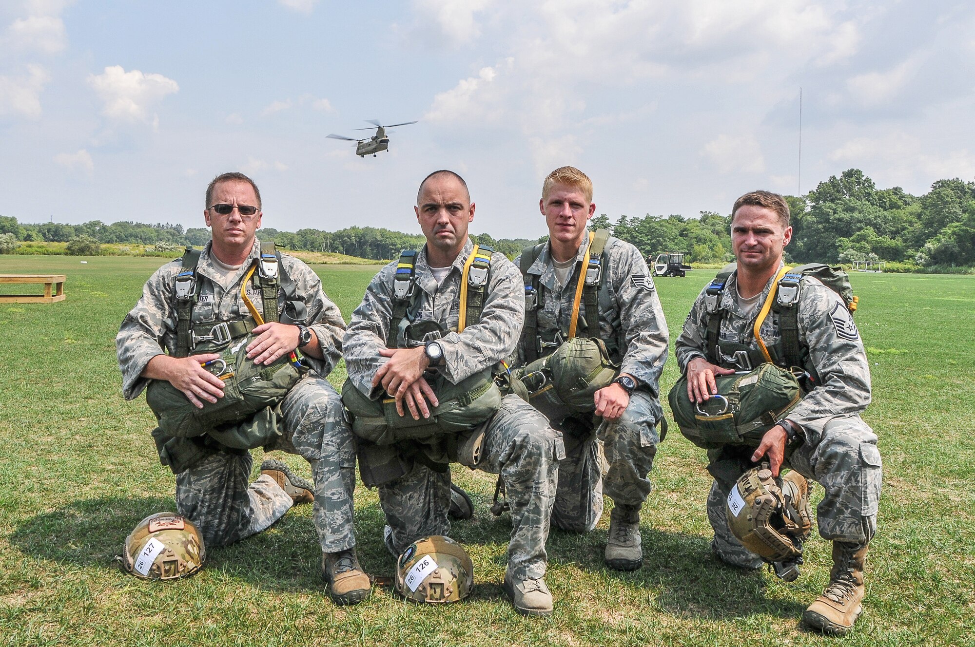 National Guard Senior Master Sgt. A.J. Freshwater, National Guard Capt. Roger Brooks, National Guard Staff Sgt. Richard Player, and National Guard Master Sgt. Ryan Baker take a knee prior to their first jump at Leapfest 30, Aug. 3, 2012 in Kingston, RI. Leapfest is an annual static jump competition featuring teams from the U.S. Air Force, Army, Reserves, and National Guard and nine foreign countries. (National Guard photo by Staff Sgt. Monica Eusebio/released)