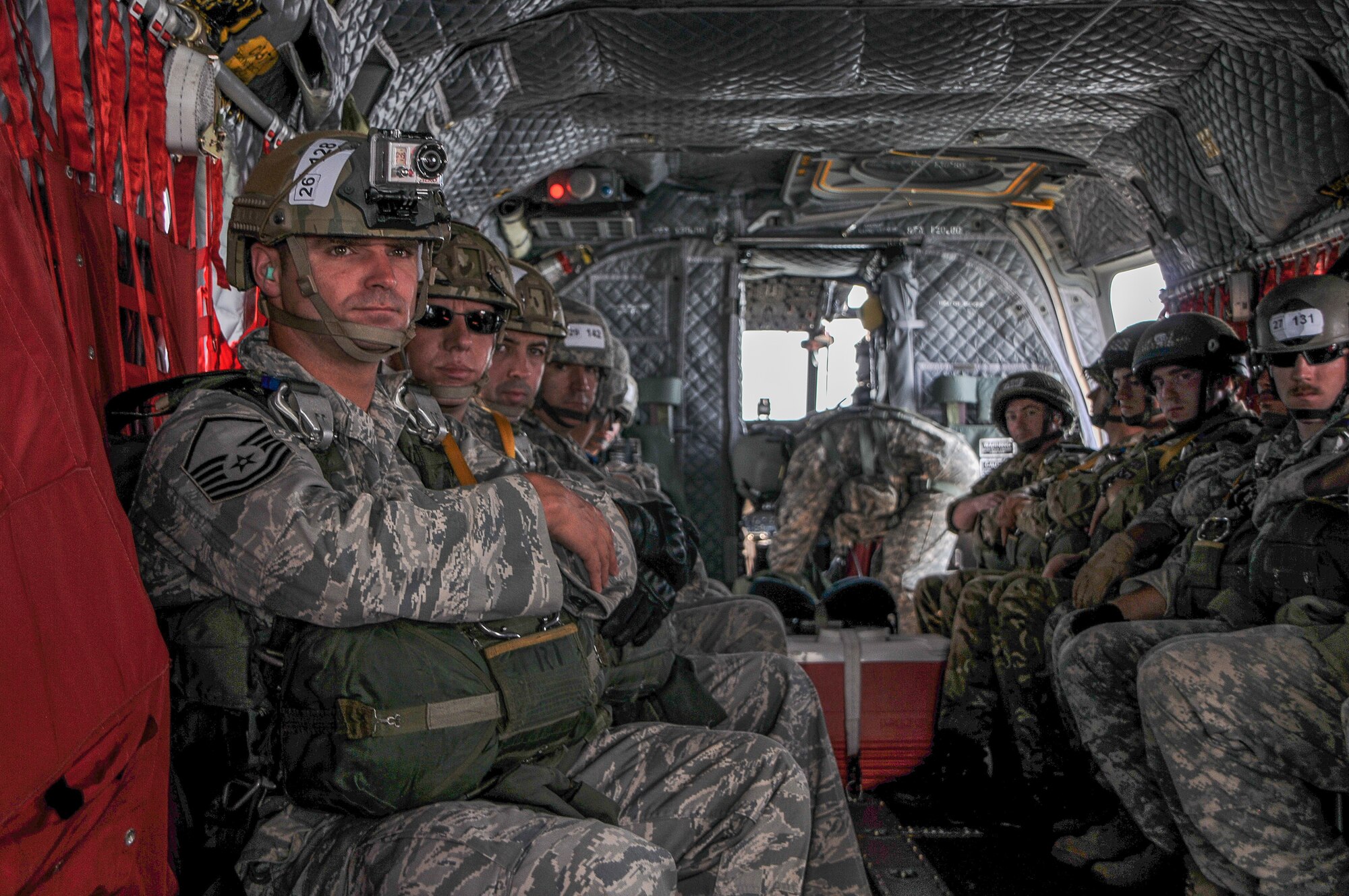 National Guard Master Sgt. Ryan Baker, National Guard Senior Master Sgt. A.J. Freshwater, and National Guard Capt. Roger Brooks wait onboard a CH-47 Chinook Helicopter during Leapfest 30, Aug. 3, 2012 in Kingston, RI. Baker, Freshwater, and Brooks are part of a four man parachuting team from the 165th Air Support Operation Squadron in Savannah, Ga. (National Guard photo by Staff Sgt. Monica Eusebio/released)