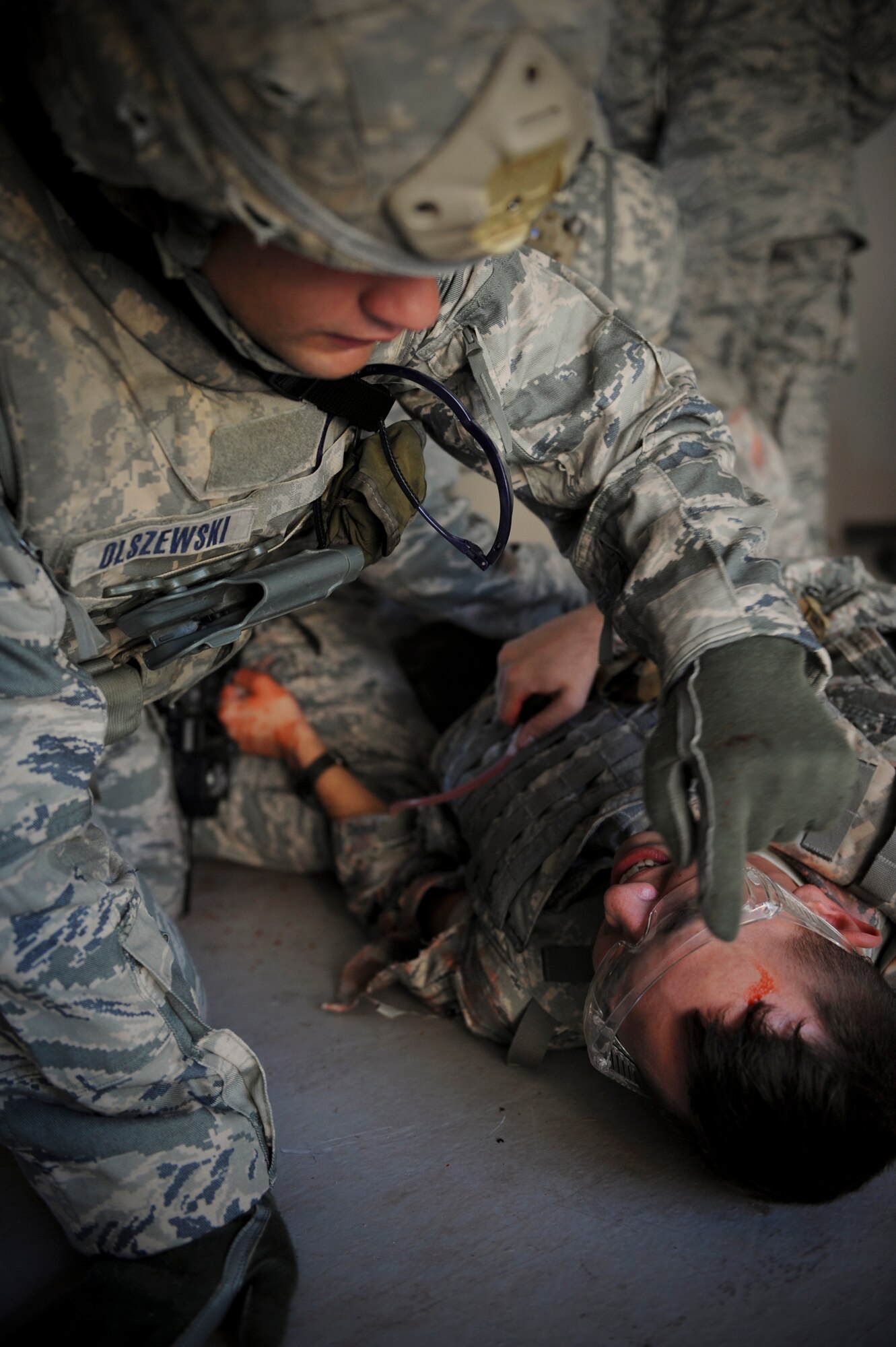 U.S. Air Force Staff Sgt. Joshua Olszewski, 822nd Base Defense Squadron fireteam leader, marks the time on the forehead of a casualty during self-aid and buddy care training with principles of tactical combat casualty care at Moody Air Force Base, Ga., Sept. 5, 2012. The purpose of writing the time on a patient’s forehead is to inform medical personnel how long the tourniquet has been in place. (U.S. Air Force photo by Senior Airman Douglas Ellis/Released)
