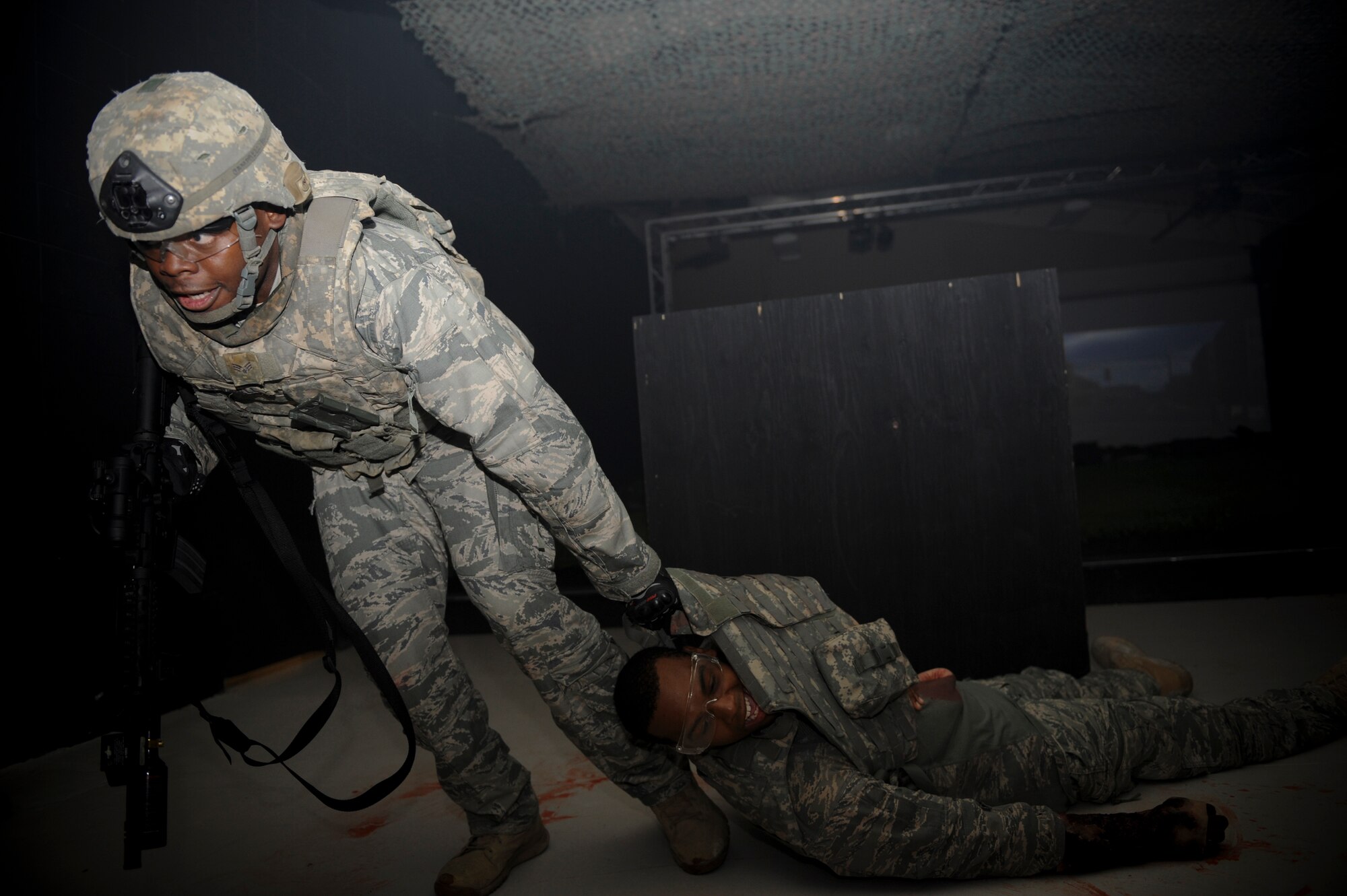 U.S. Air Force Senior Airman Kenneth Campbell, 822nd Base Defense Squadron fireteam leader, drags an injured person to safety during self-aid and buddy care training with principles of tactical combat casualty care at Moody Air Force Base, Ga., Sept. 5, 2012. After getting the casualty to safety, Campbell performed SABC and evacuated the casualties. (U.S. Air Force photo by Senior Airman Douglas Ellis/Released)
