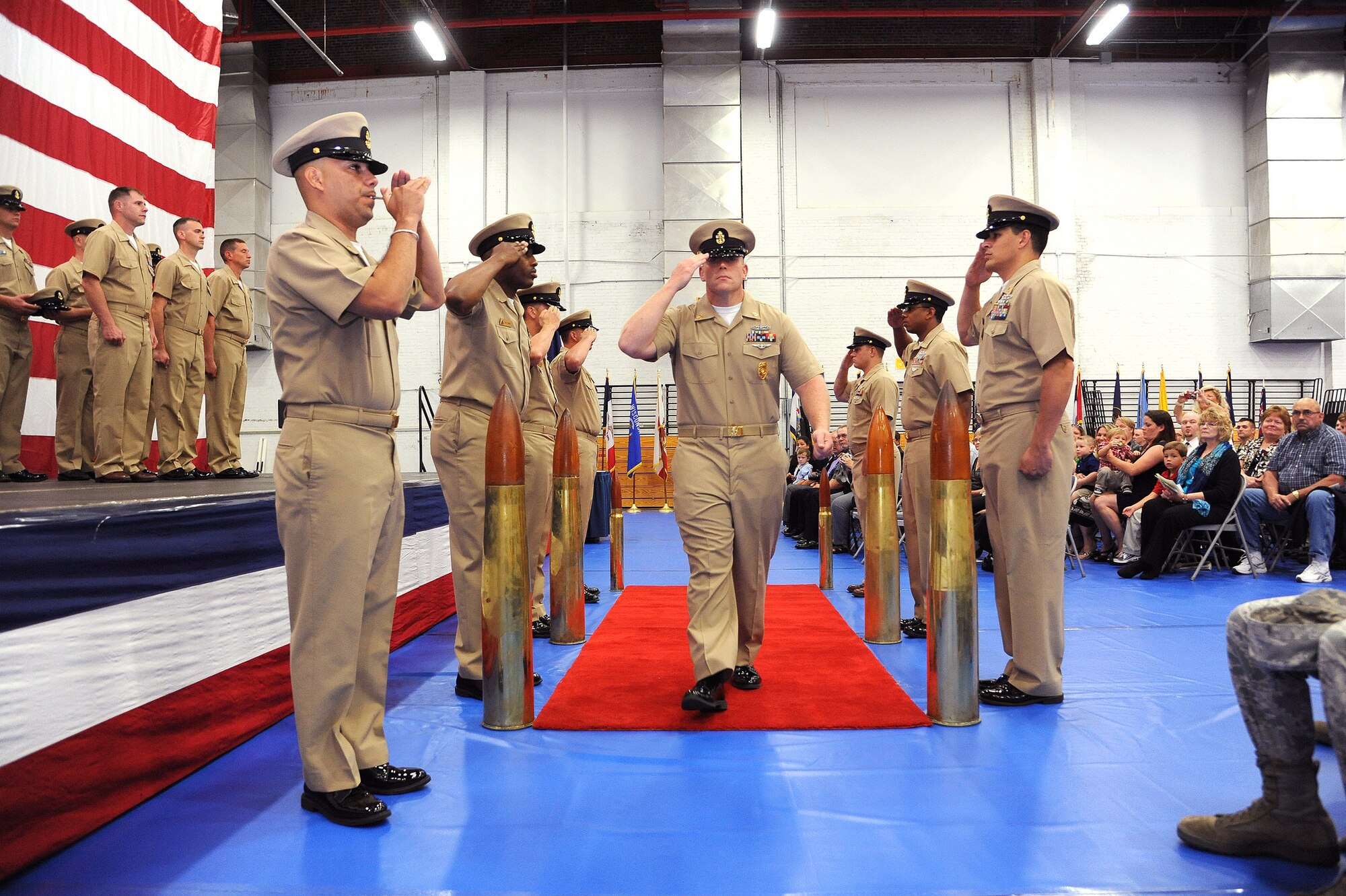 Chief Petty Officer Patrick McKay, 87th Security Force Squadron Lakehurst detachment chief master at arms, gets piped aboard after being pinned with chief's gold fouled anchor Sept. 14 during the chief pinning ceremony at the Lakehurst Fitness and Sports Center here. The time-honored naval tradition of the chief's pinning dates back to 1893, when the chief petty officer pay grade was created. (U.S. Air Force photo by Russ Meseroll/Released)
