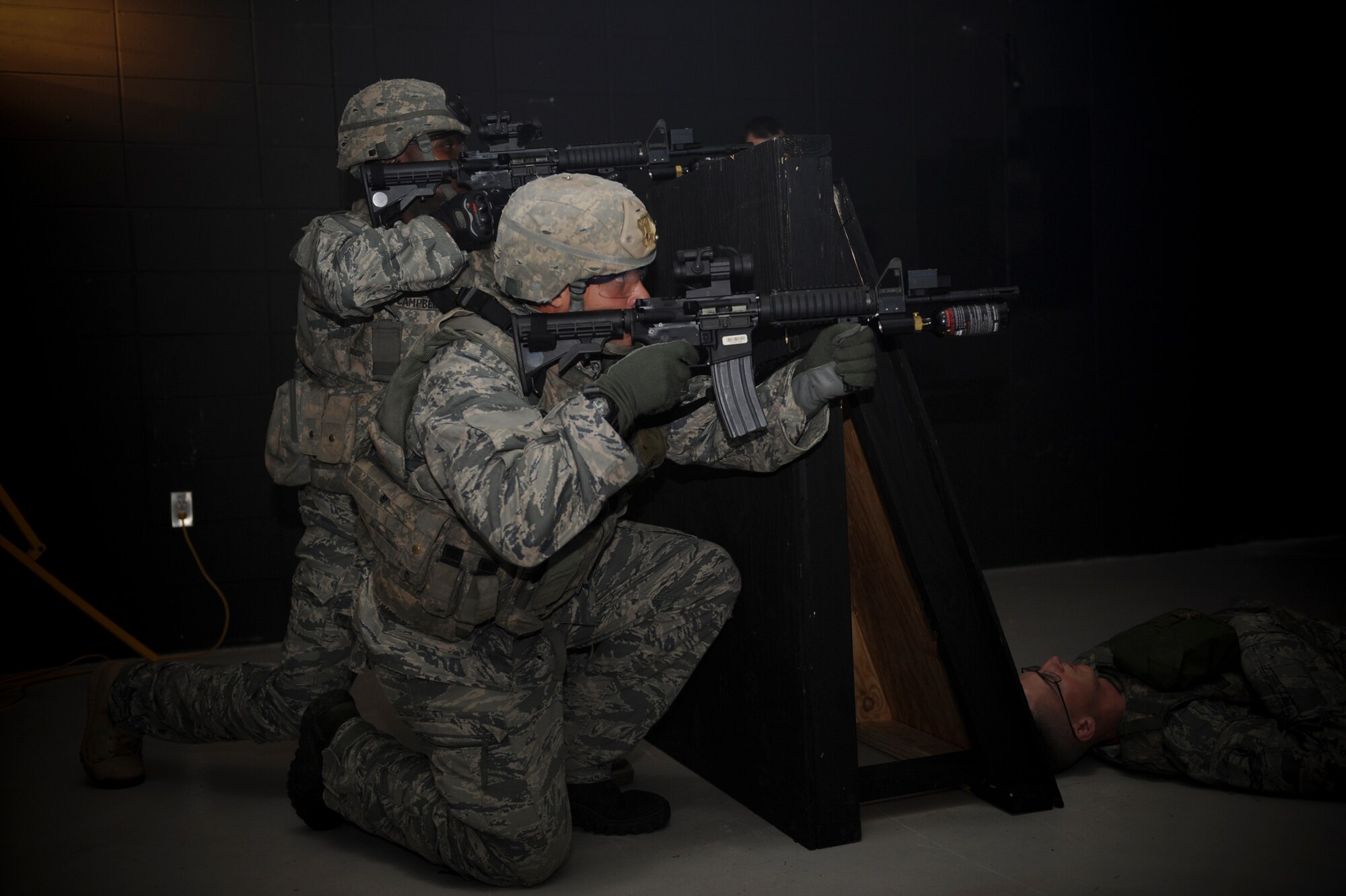 Airmen from the 822nd Base Defense Squadron fire at opposing forces during self-aid and buddy care training with principles of tactical combat casualty care at Moody Air Force Base, Ga., Sept. 5, 2012. The SABC TCCC training is an annual requirement for members of the 820th Base Defense Group. (U.S. Air Force photo by Senior Airman Douglas Ellis/Released)
