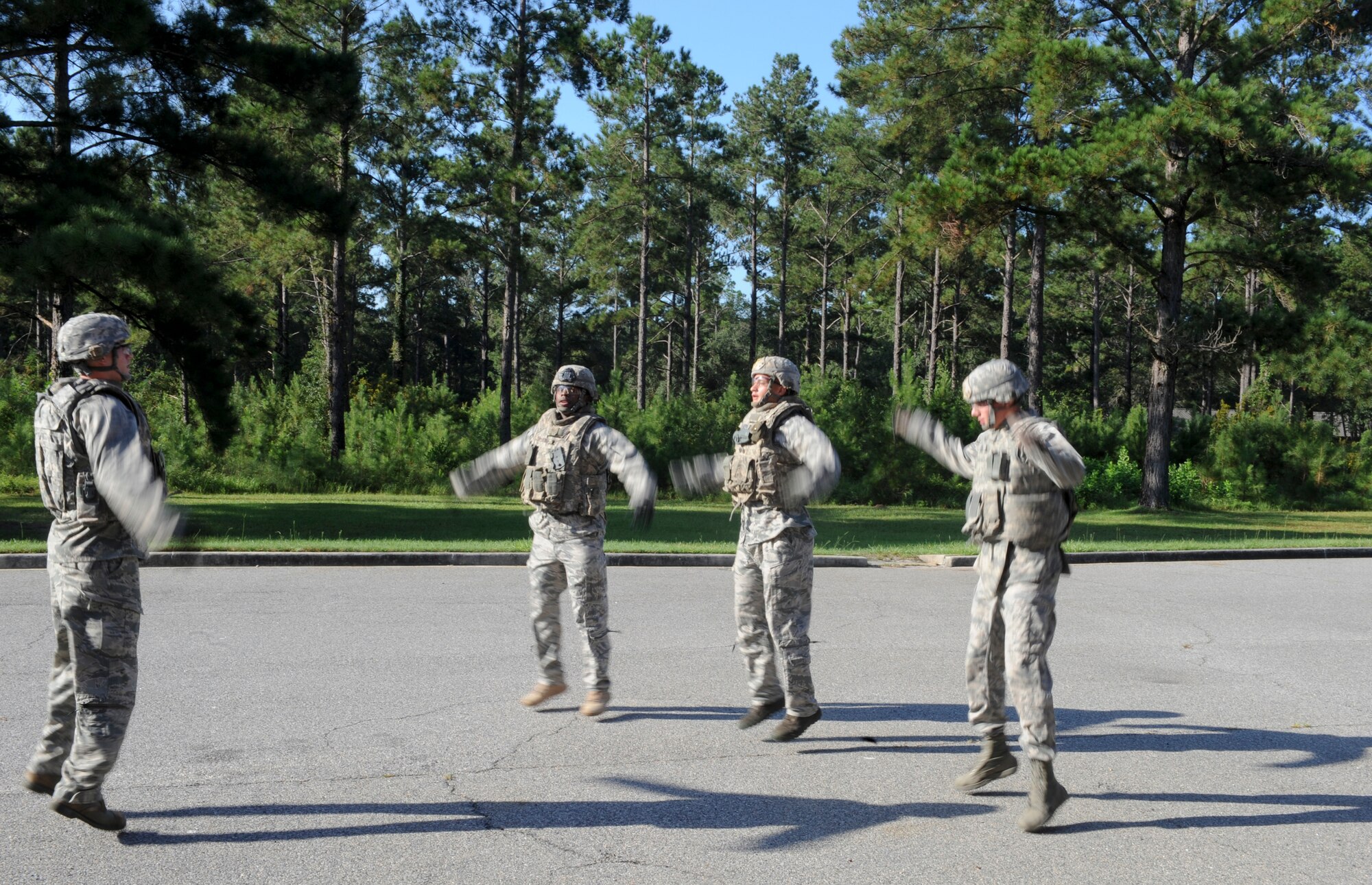 Airmen from the 822nd Base Defense Squadron perform jumping jacks before beginning self-aid and buddy care training with principles of tactical combat casualty care at Moody Air Force Base, Ga., Sept. 5, 2012. The participants also ran and performed pushups prior to the scenario to imitate the stress and higher heart rate of being in a combat environment. (U.S. Air Force photo by Senior Airman Douglas Ellis/Released) 
