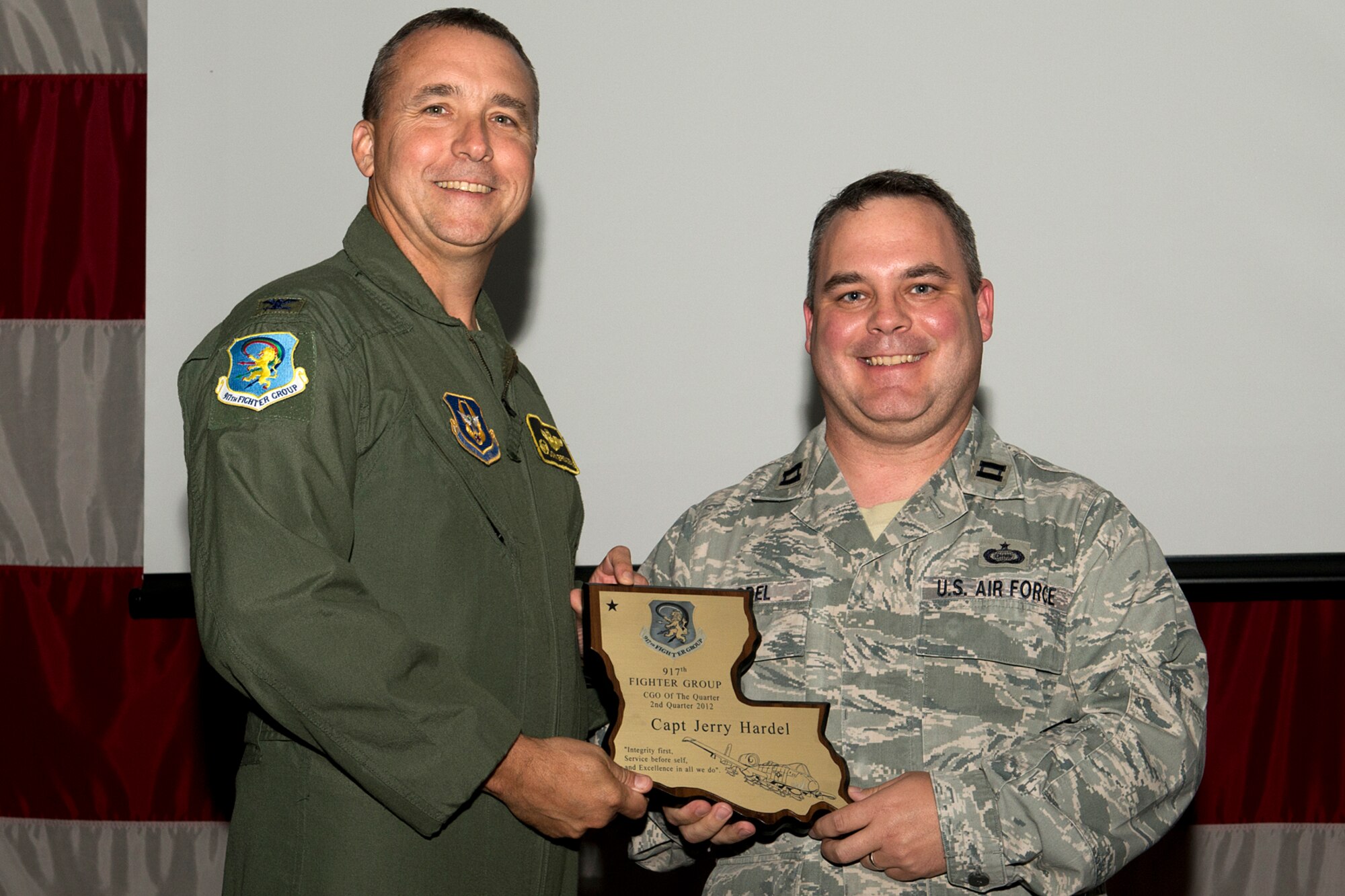 U.S. Air Force Col. John Breazeale, 917th Fighter Group commander, presents an award to Capt. Jerry Hardel during a Commander's Call ceremony, Sept. 9, 2012, Barksdale Air Force Base, La. Hardel was selected as the Company Grade Officer of the Quarter, 2nd Quarter 2012. (U.S. Air Force photo by Master Sgt. Greg Steele/Released)