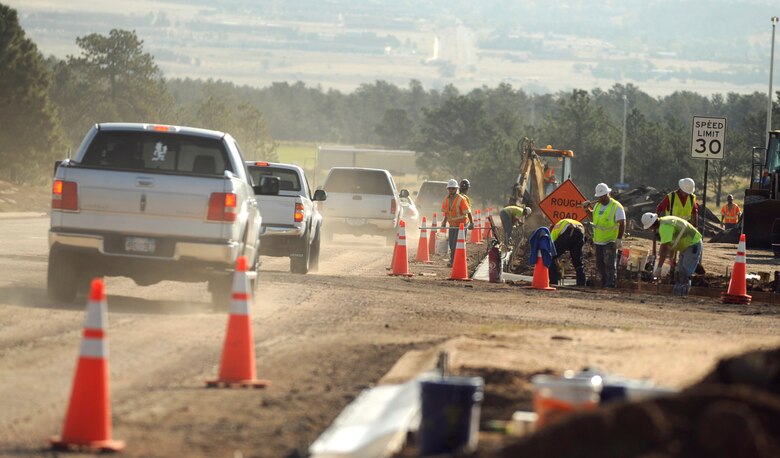 Construction workers install curbing along Community Center Drive on Sept. 20, 2012. Construction along Community Center Drive and in the Base Exchange parking lot will add drainage pipes, inlets and curbs. (U.S. Air Force photo/Carol Lawrence)